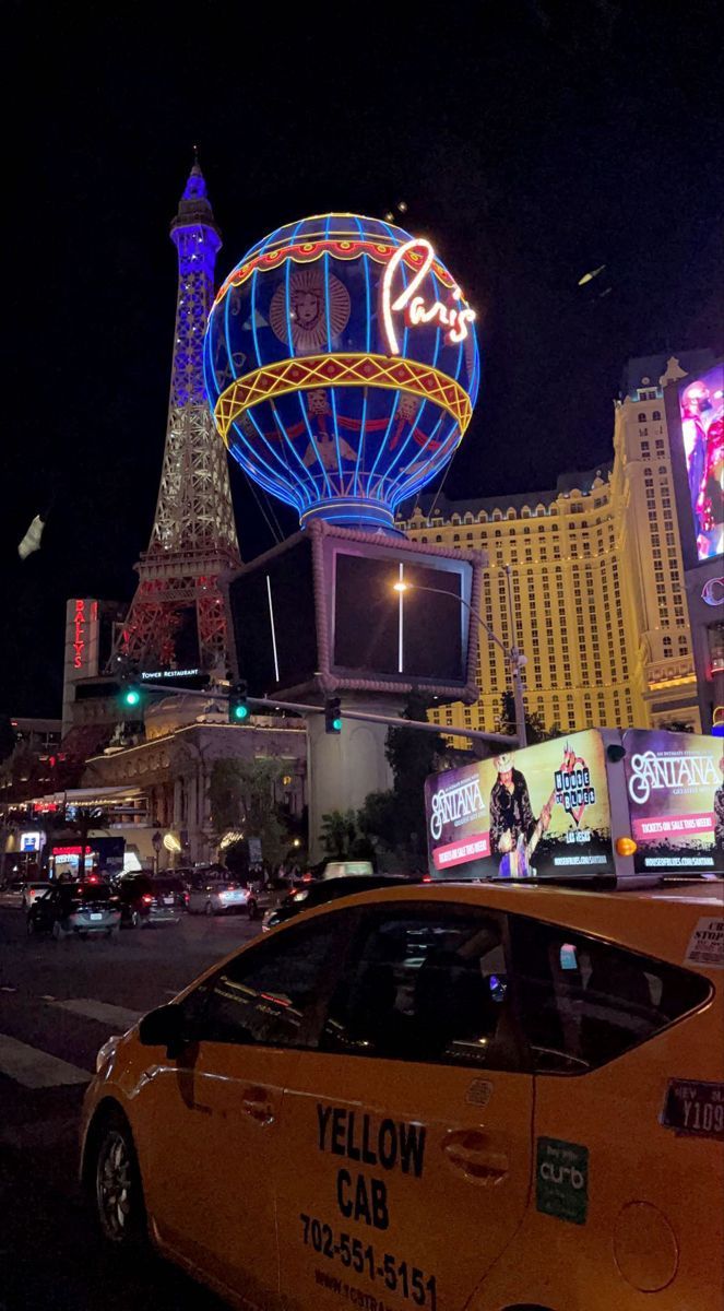 A taxi cab driving down the Las Vegas strip at night. - Las Vegas
