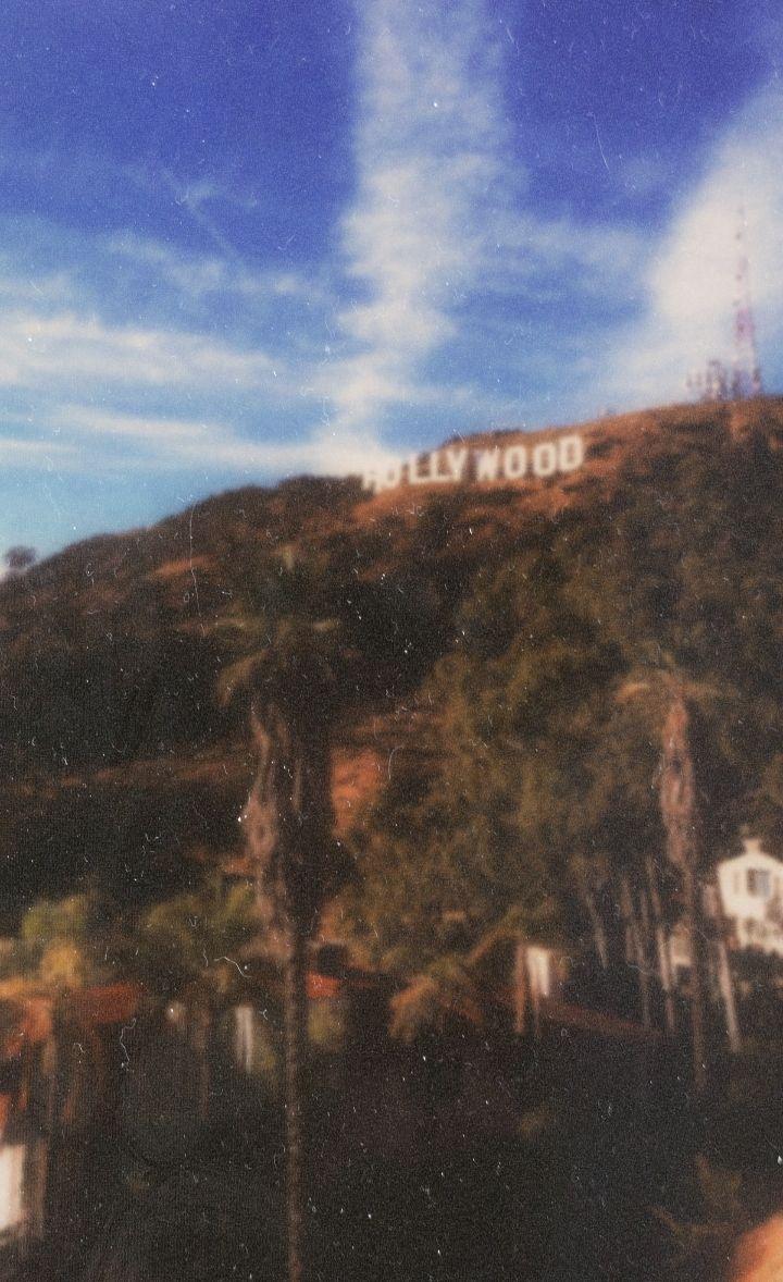 A hill with the hollywood sign on top - Los Angeles