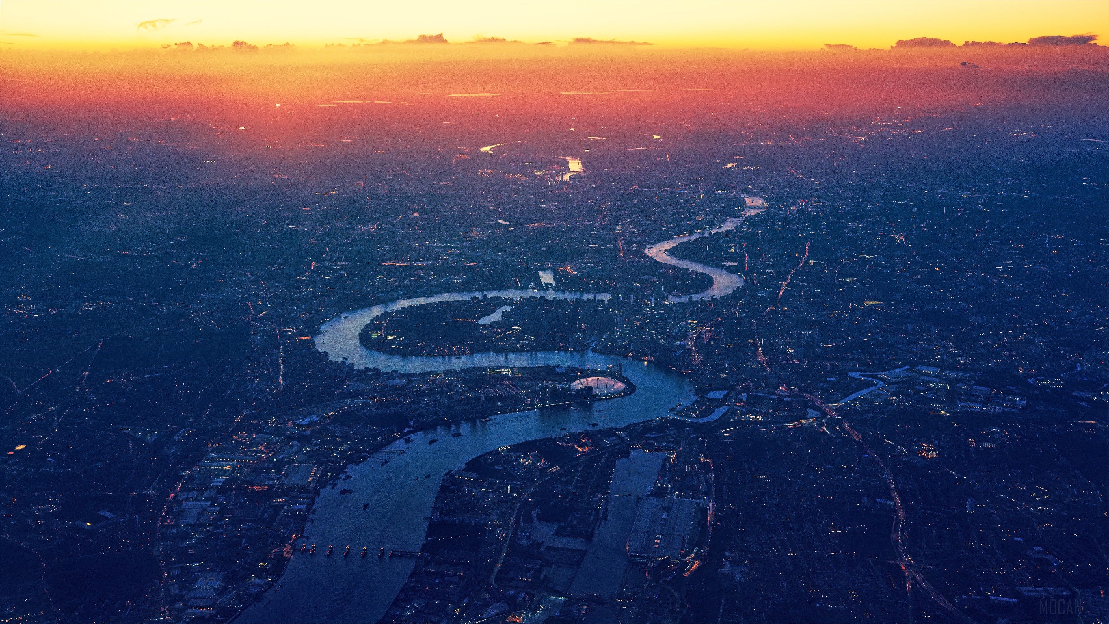 A city with water and buildings at sunset - London