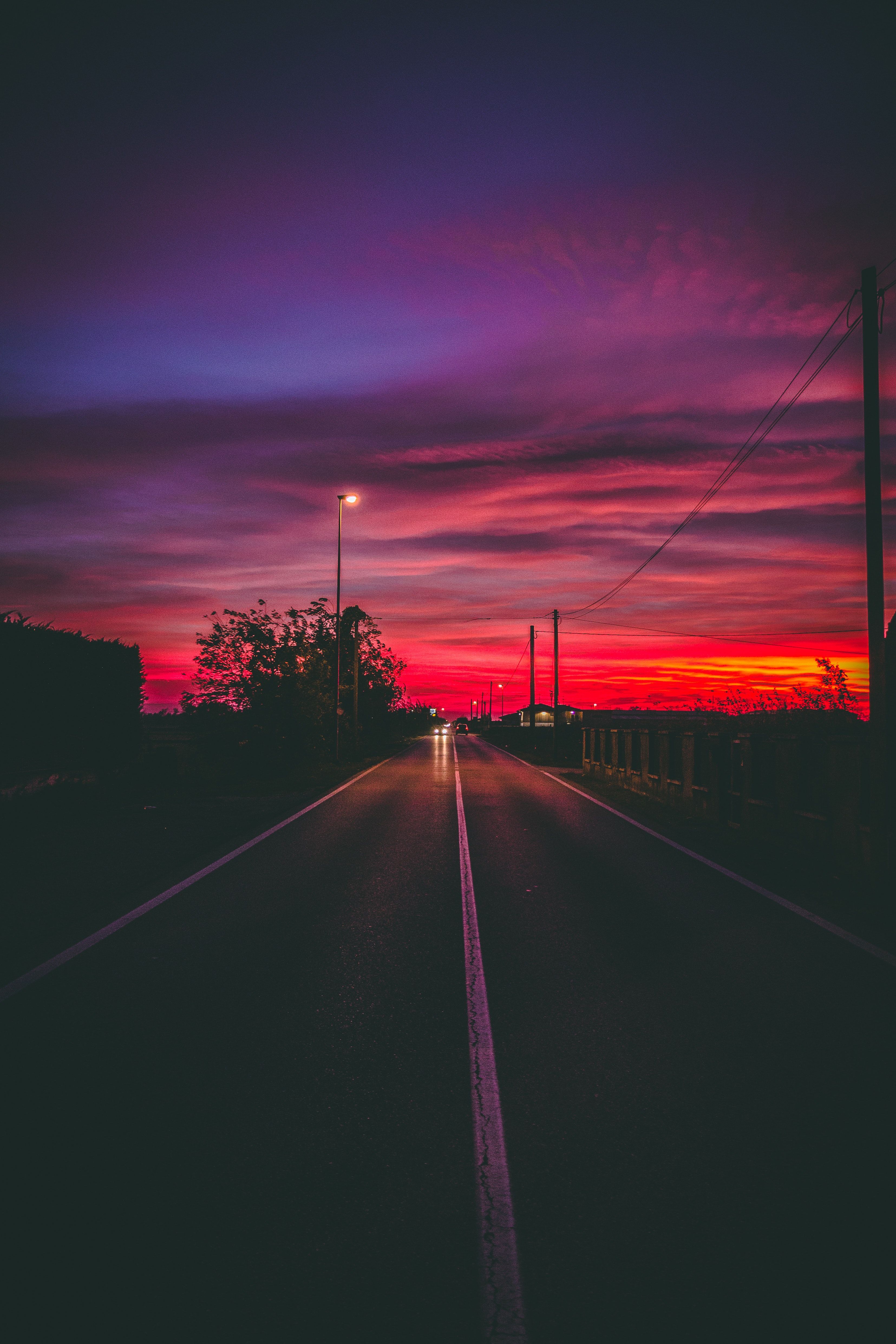 A road with no cars on it at sunset - Road