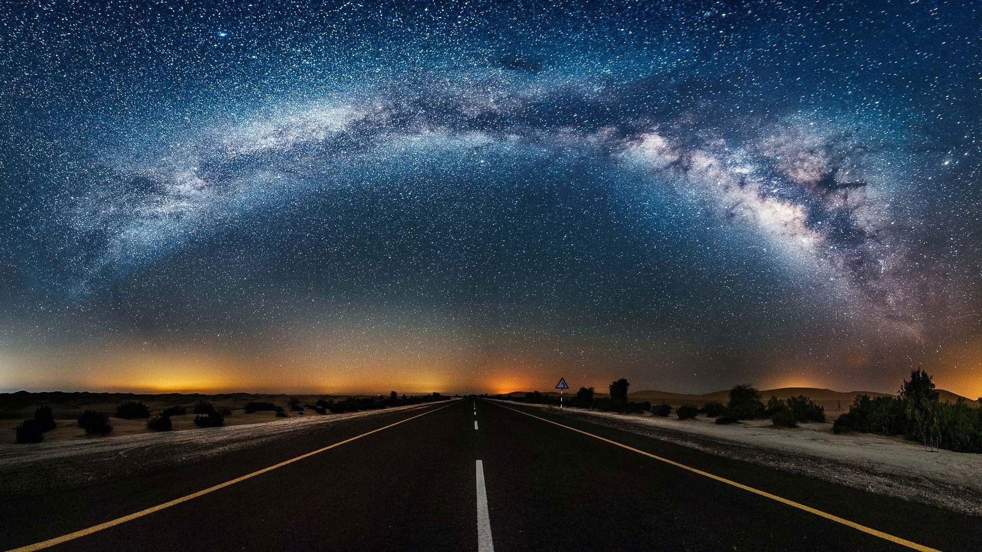 A road in the middle of nowhere with stars above - Road