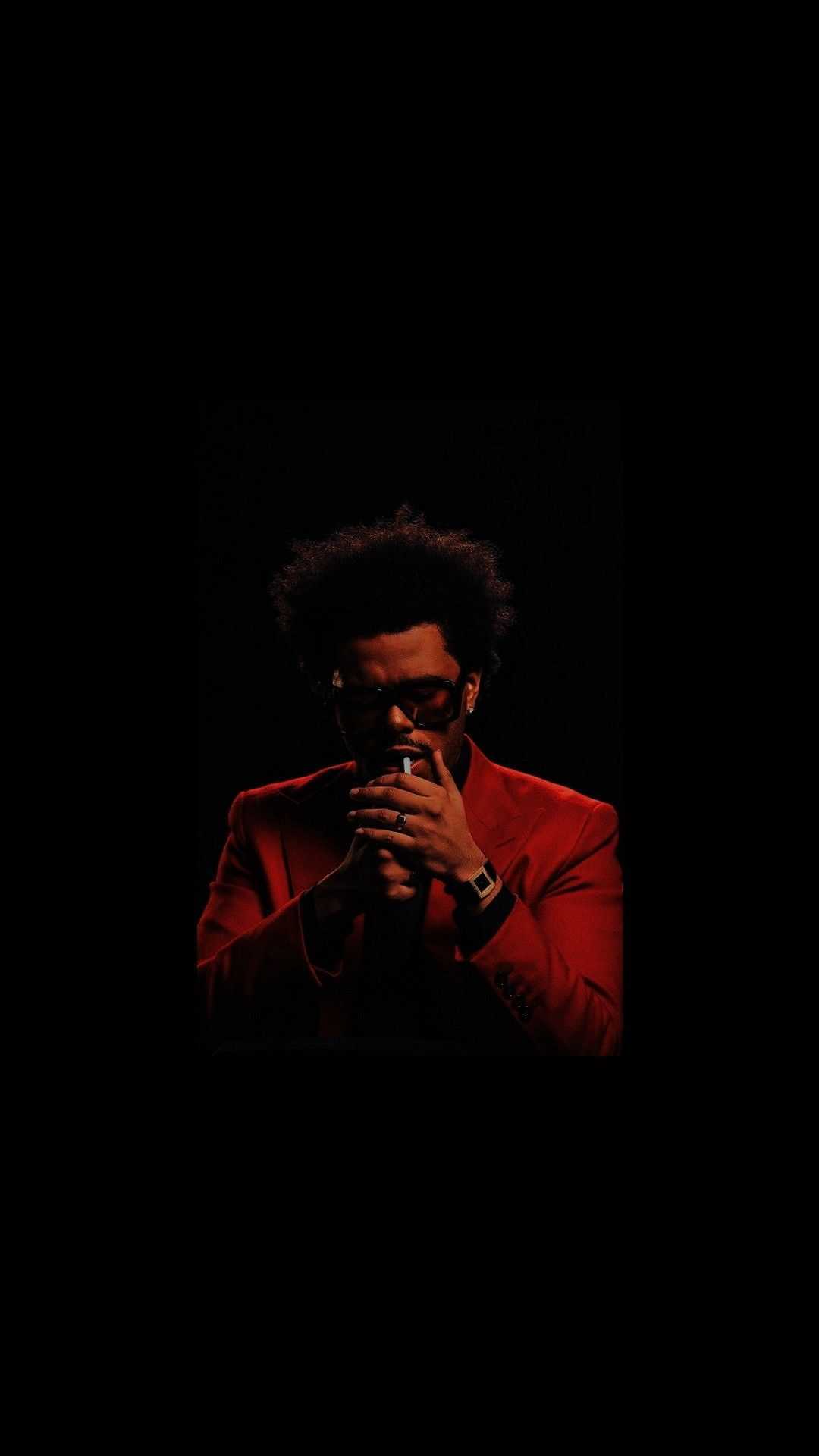 A man in red suit and sunglasses - The Weeknd