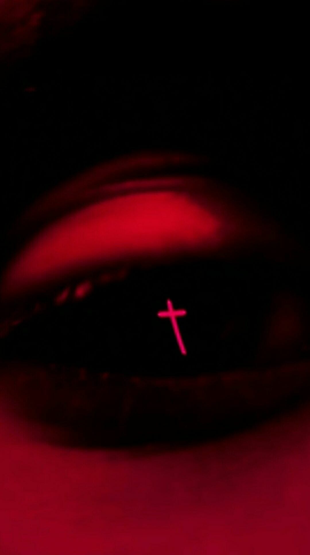 A cross is shown in the center of an eye - The Weeknd