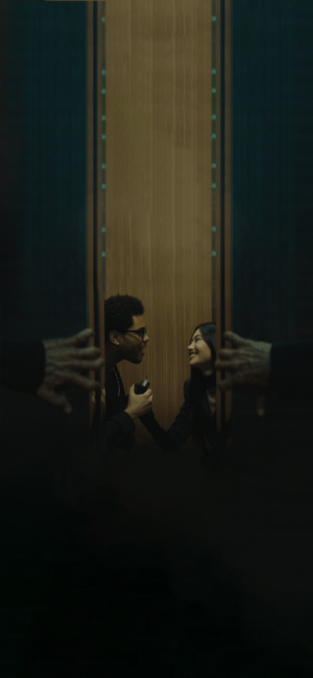 A man and a woman are standing in an elevator. - The Weeknd