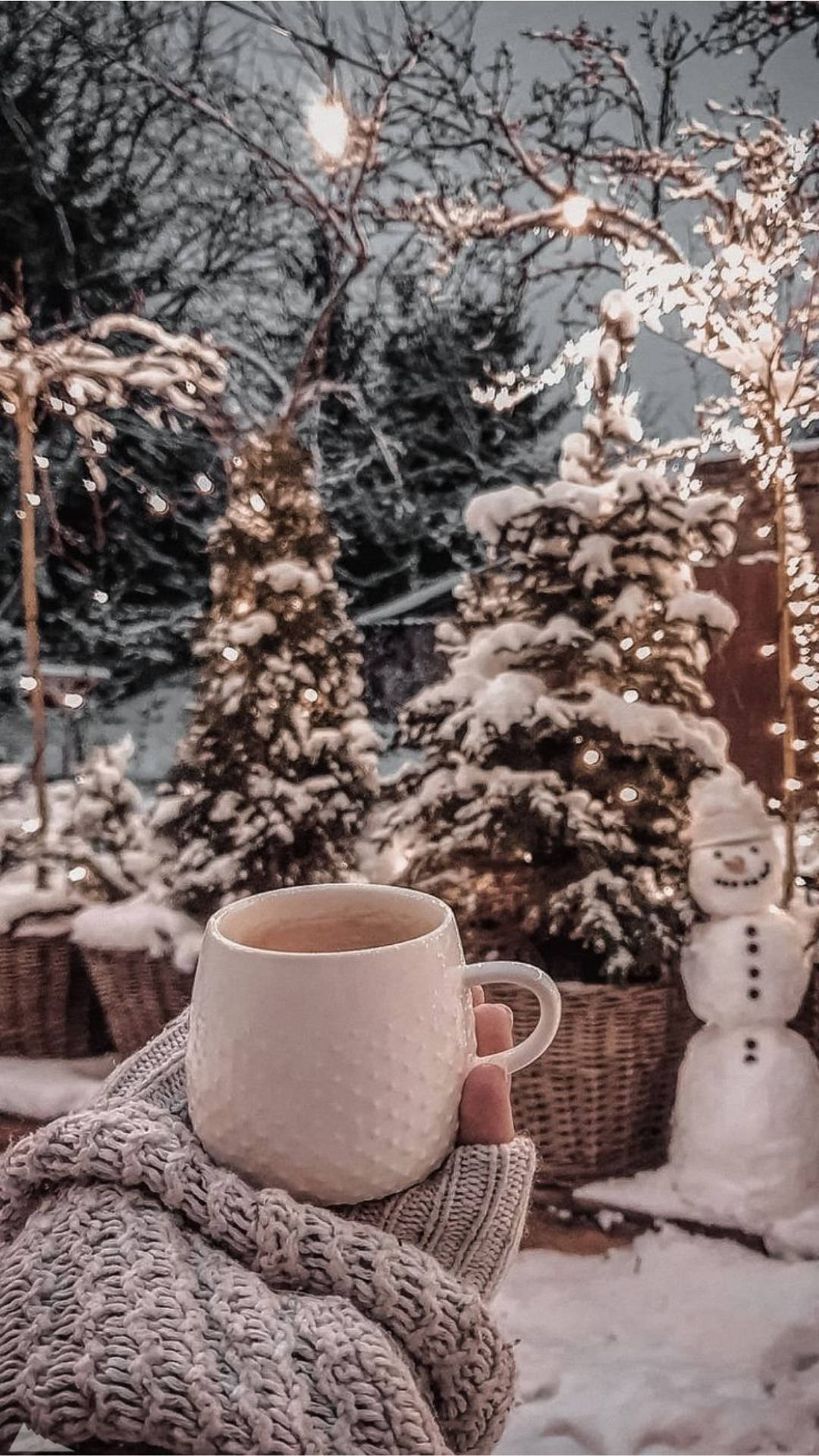 A person holding up their cup of coffee in the snow - Cozy