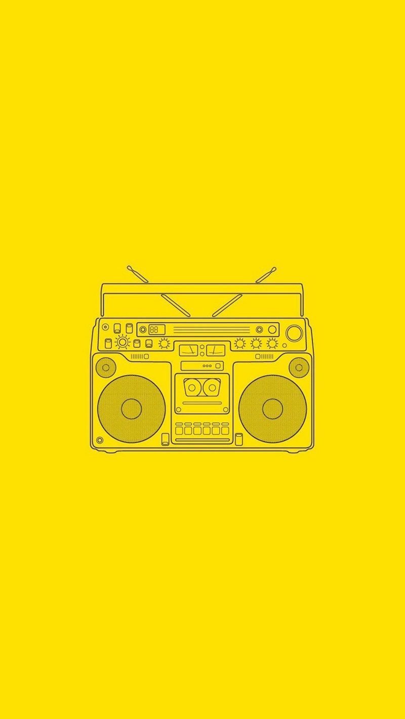 A yellow background with an old boombox - Music