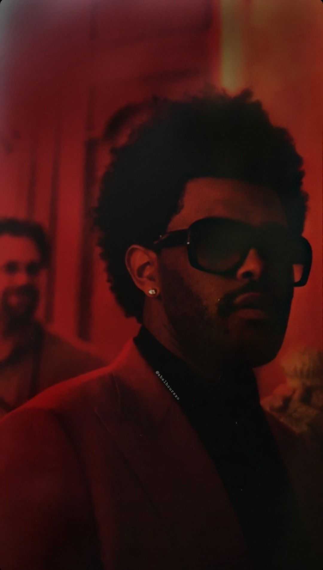 A man with an afro and sunglasses - The Weeknd