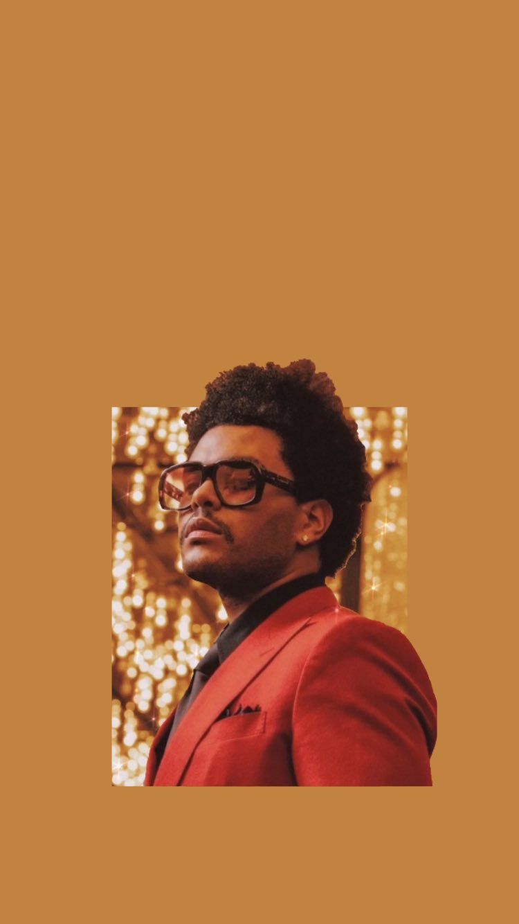 A man in glasses and red suit - The Weeknd