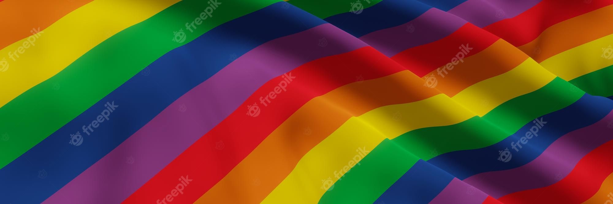 A waving rainbow flag in the wind. - Pride
