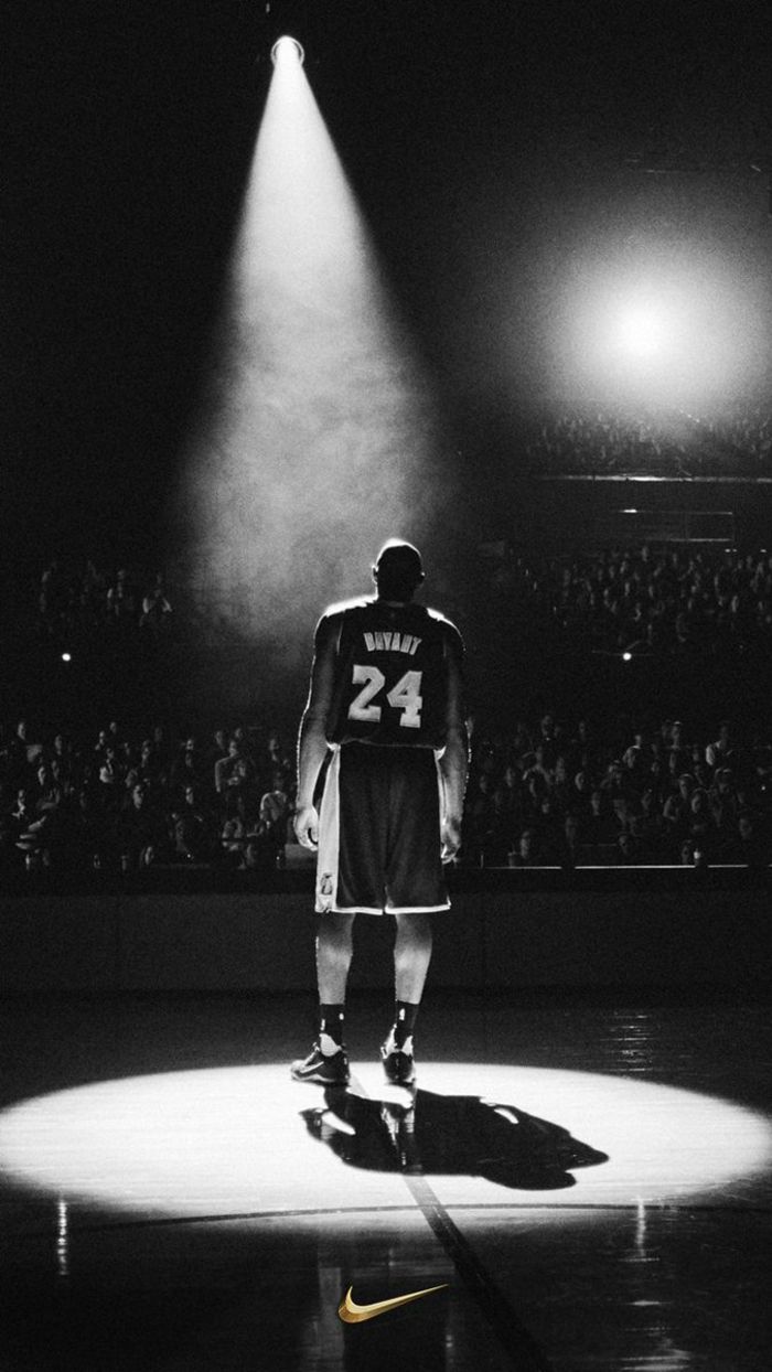 A black and white photo of Kobe Bryant standing on the basketball court. - NBA, basketball, Kobe Bryant