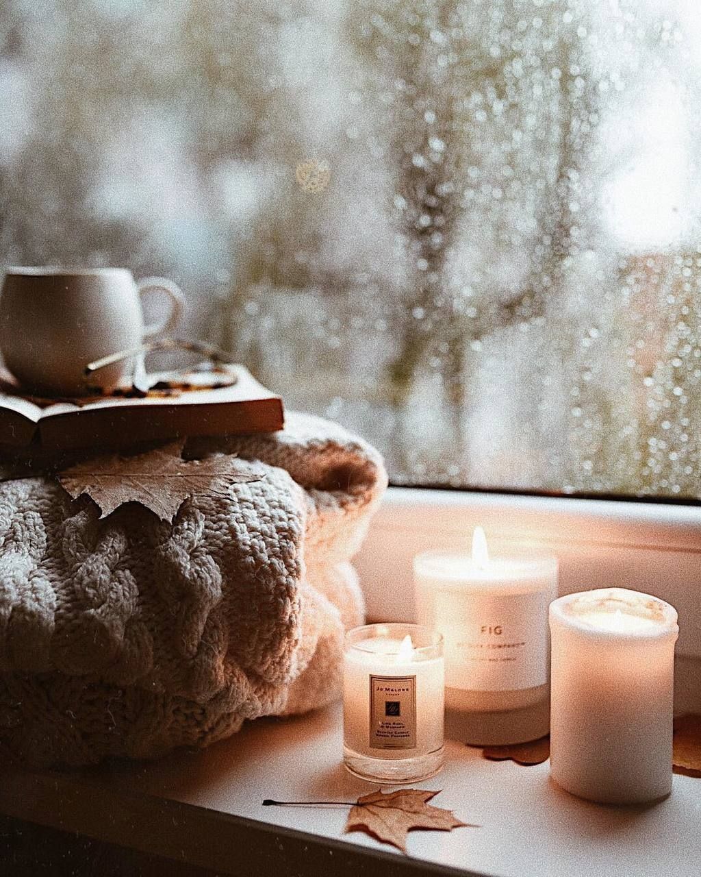 A candle and some books on the windowsill - Cozy