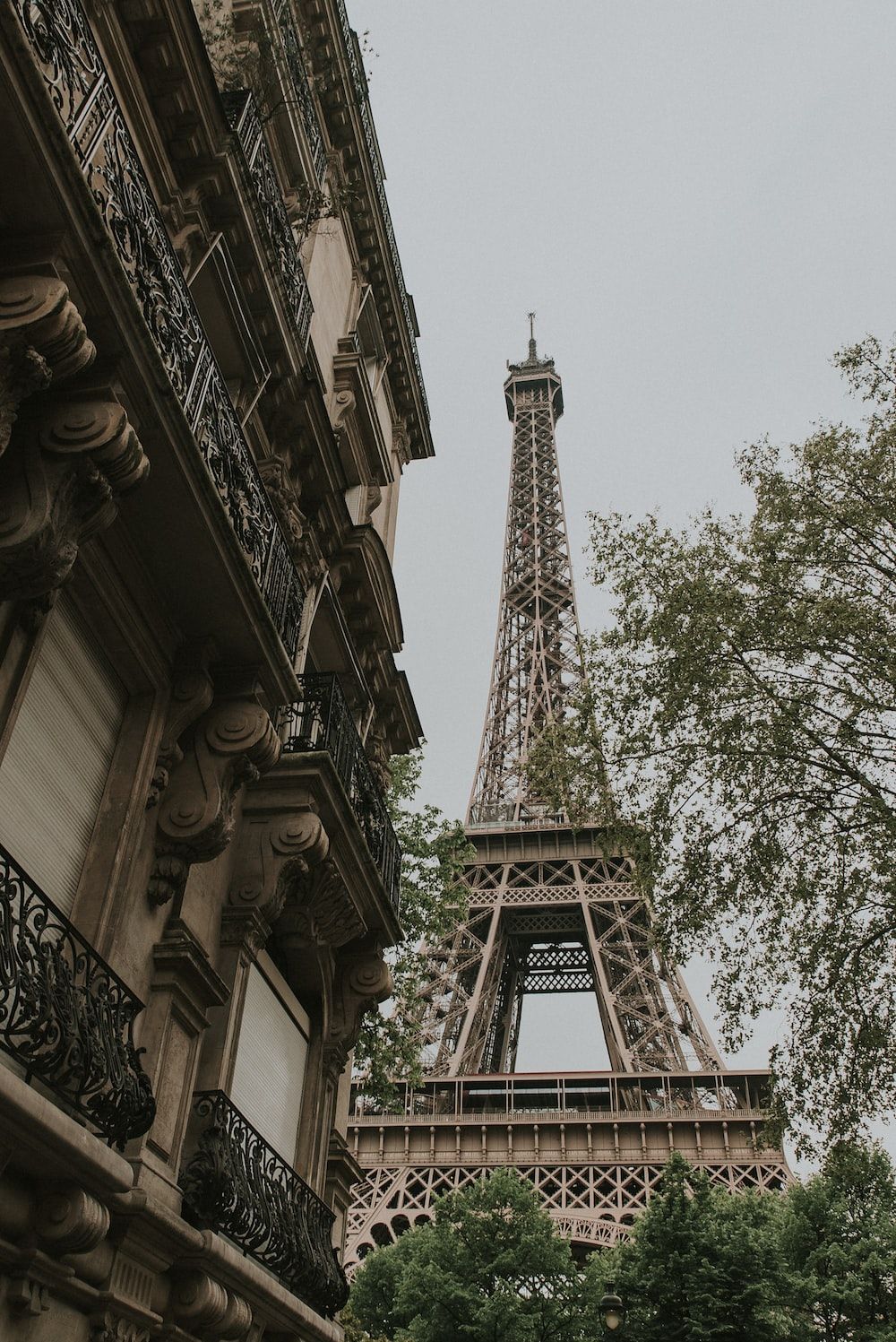 A tall building with trees in front of it - Paris, Eiffel Tower