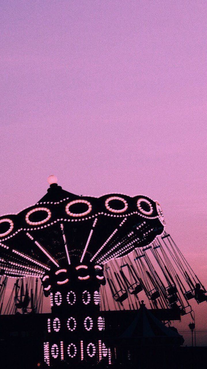 Aesthetic phone background of a carousel at sunset - 60s
