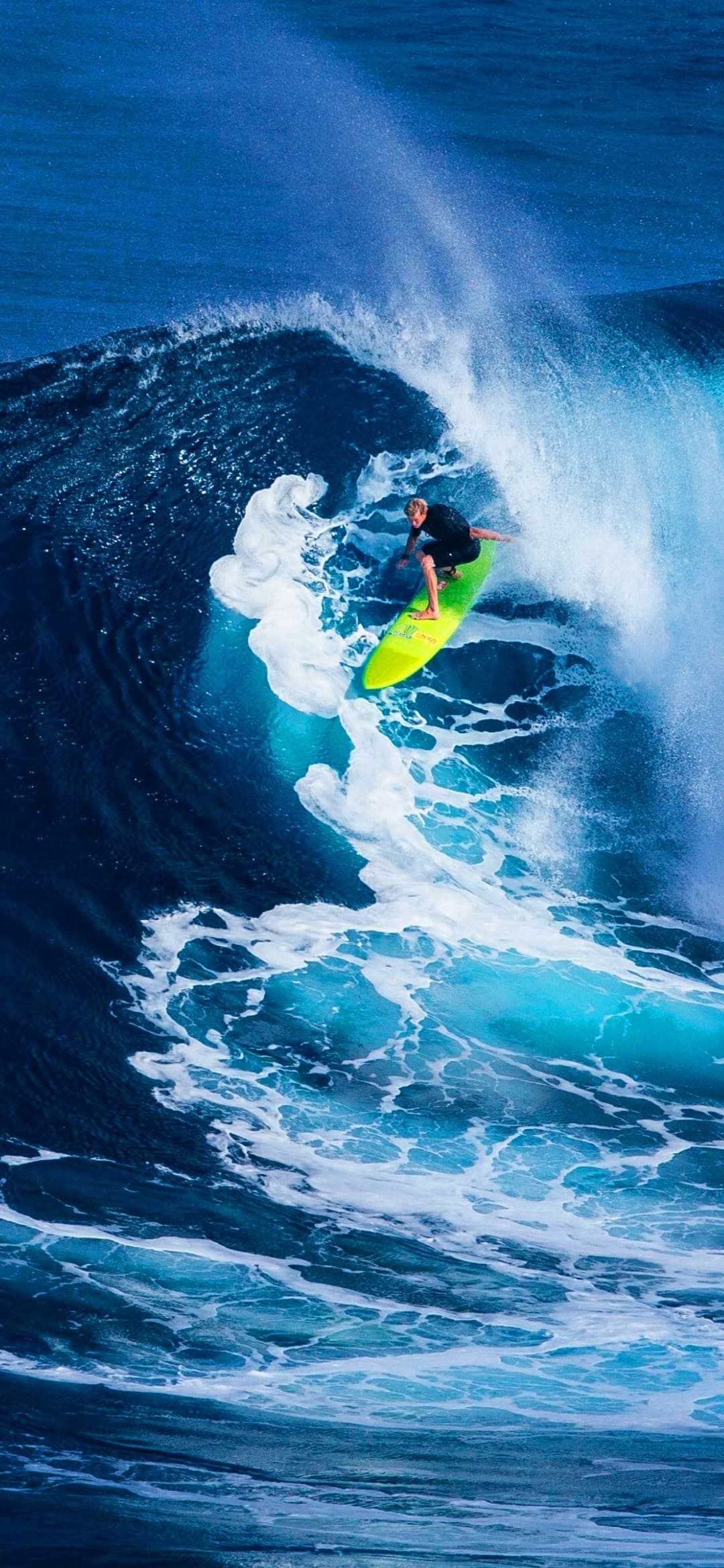 A man riding on top of an ocean wave - Surf