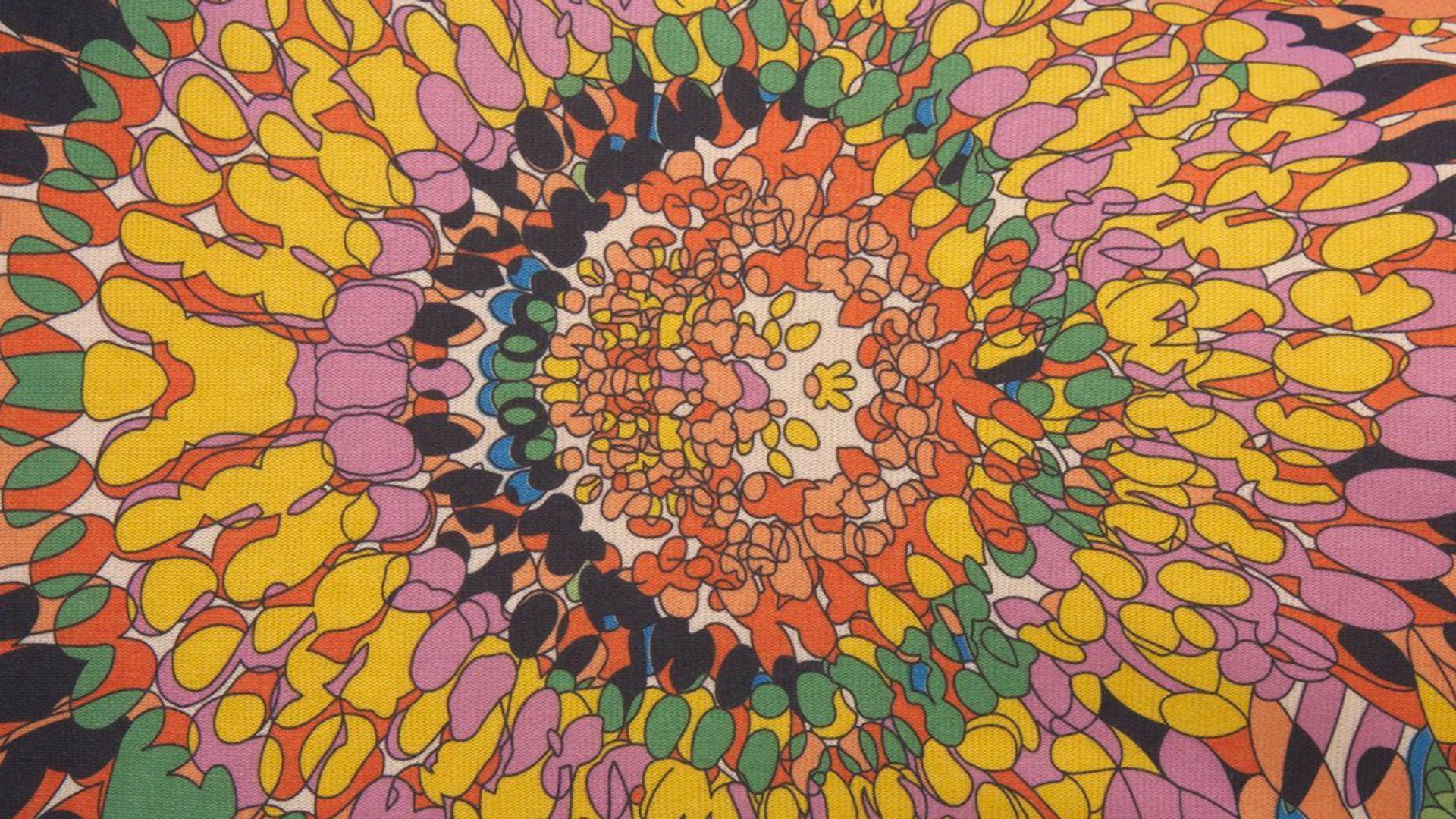 A colorful, abstract pattern of a flower on a piece of fabric - 70s, psychedelic