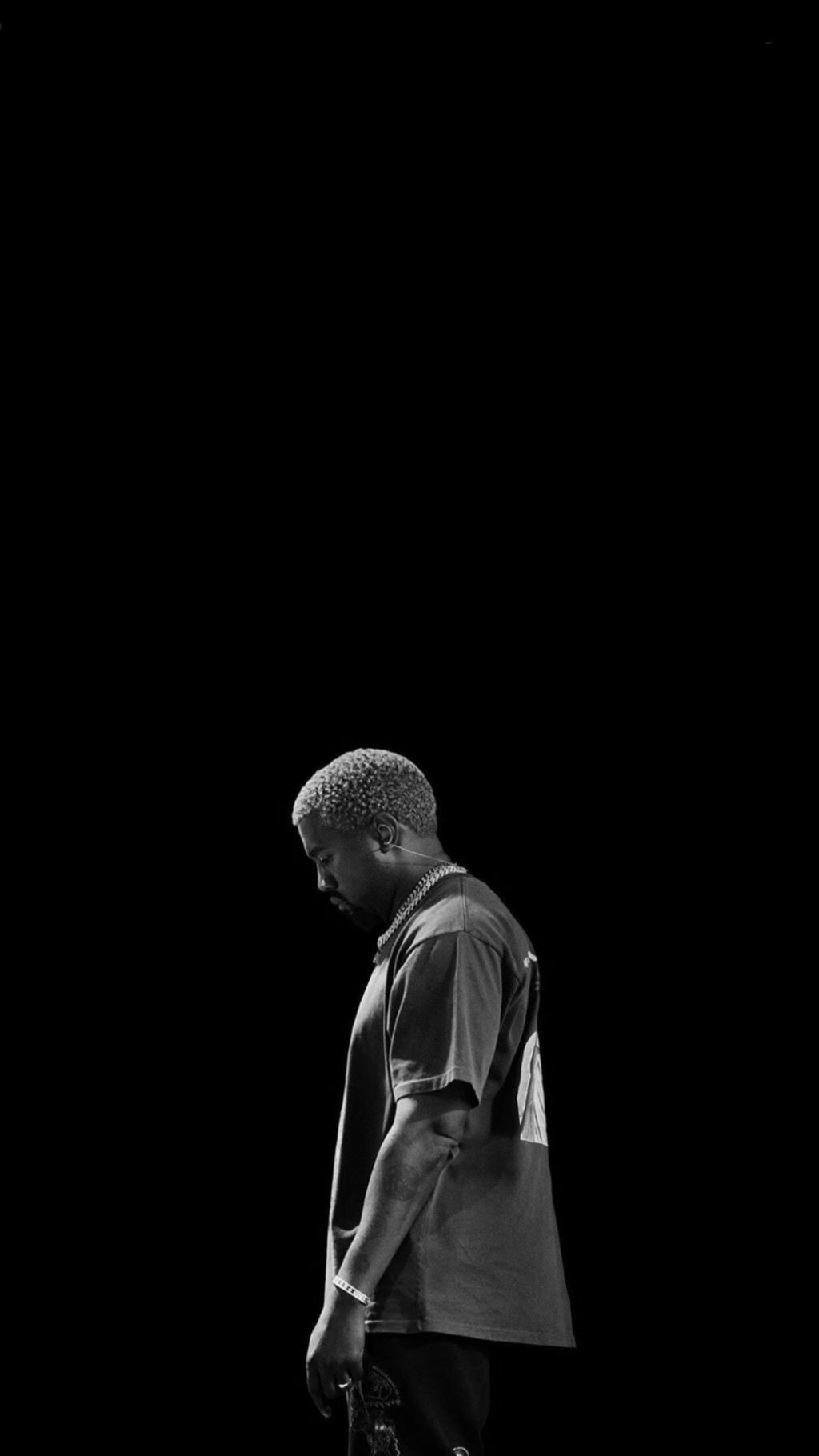 A man is standing in front of an object - Kanye West