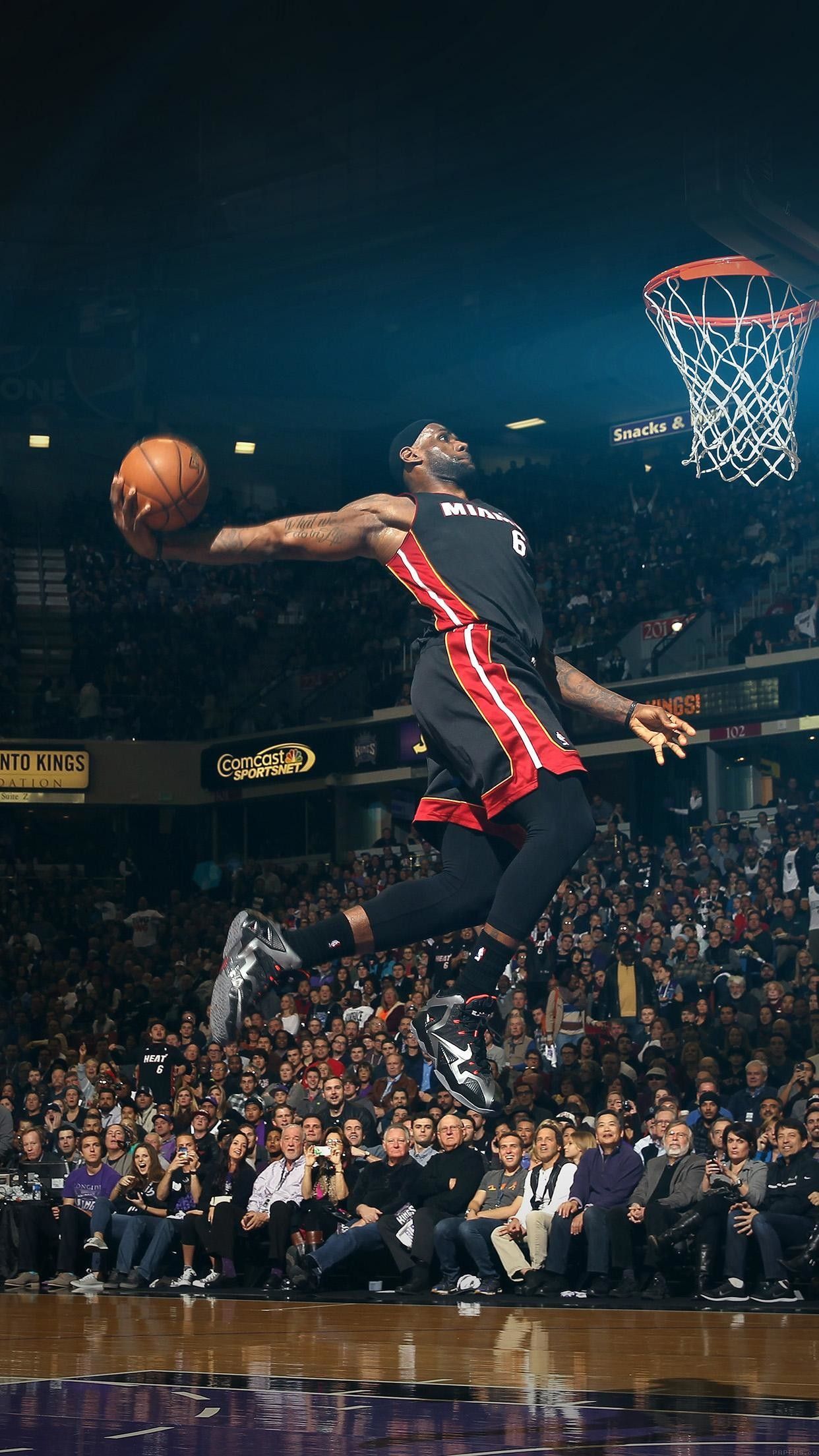 A man jumping up to grab the basketball - NBA