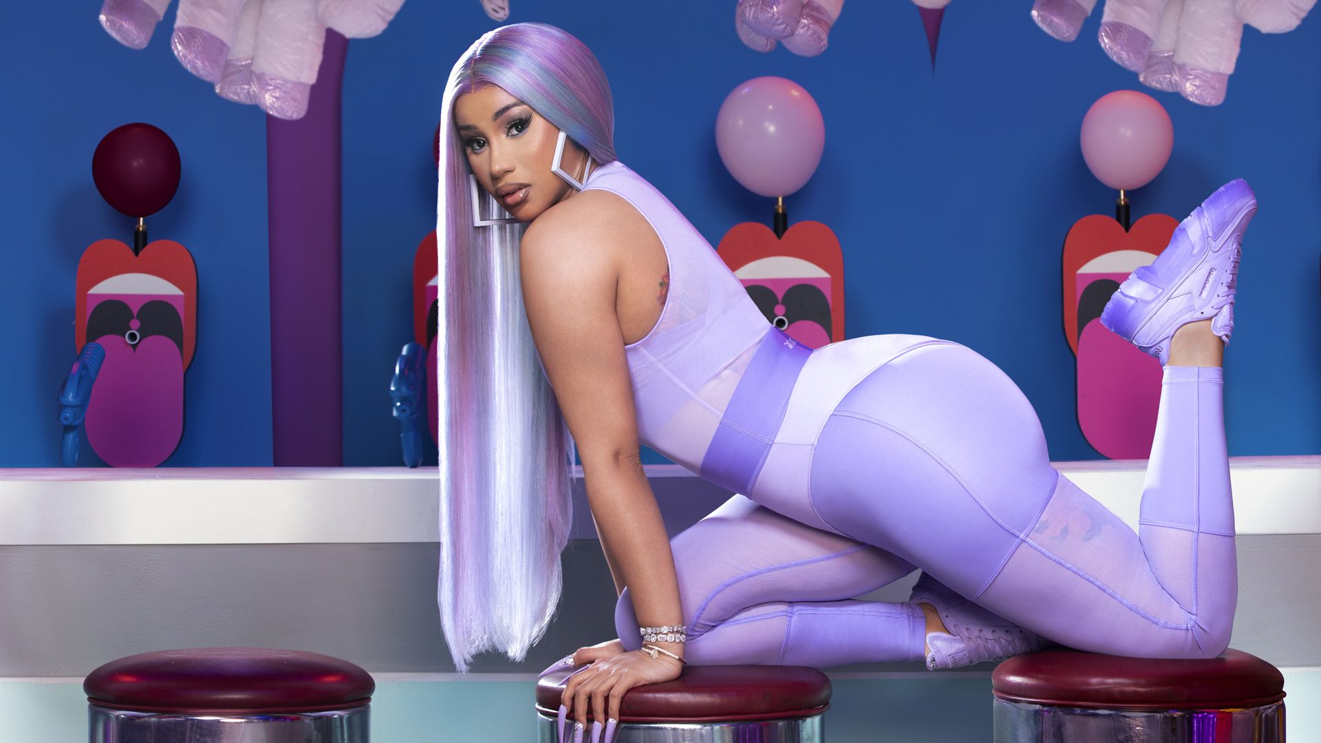 Cardi B poses in a lavender bodysuit and matching legging. - Cardi B