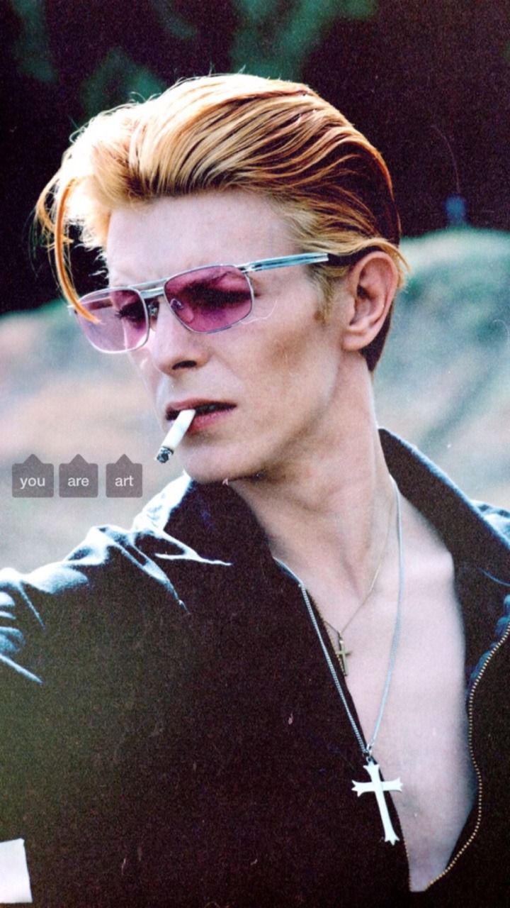 A man with sunglasses and smoking cigarette - David Bowie