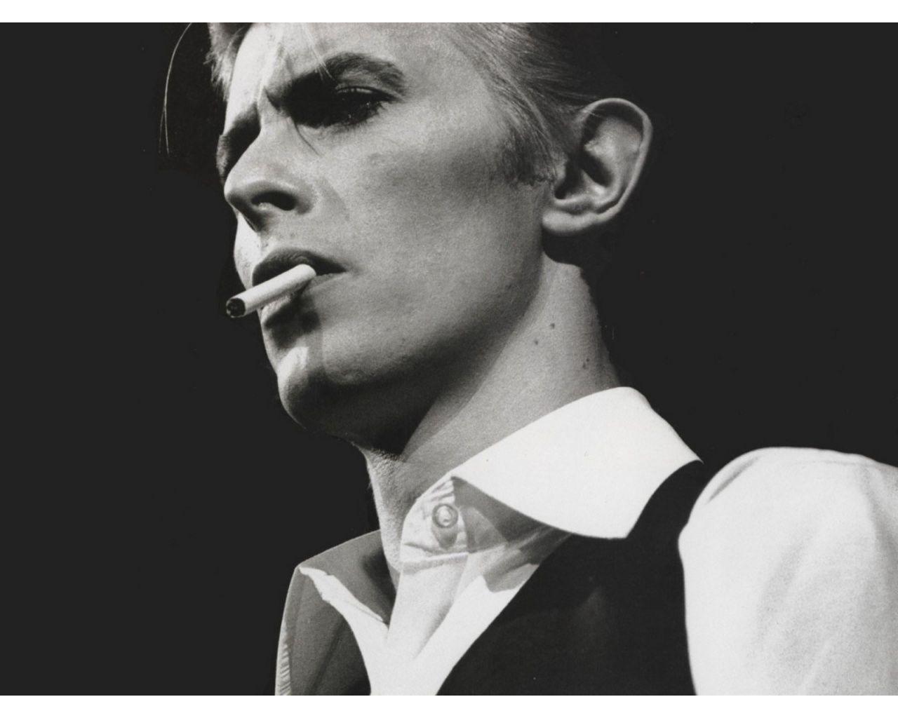 A man smoking cigarette in black and white - David Bowie