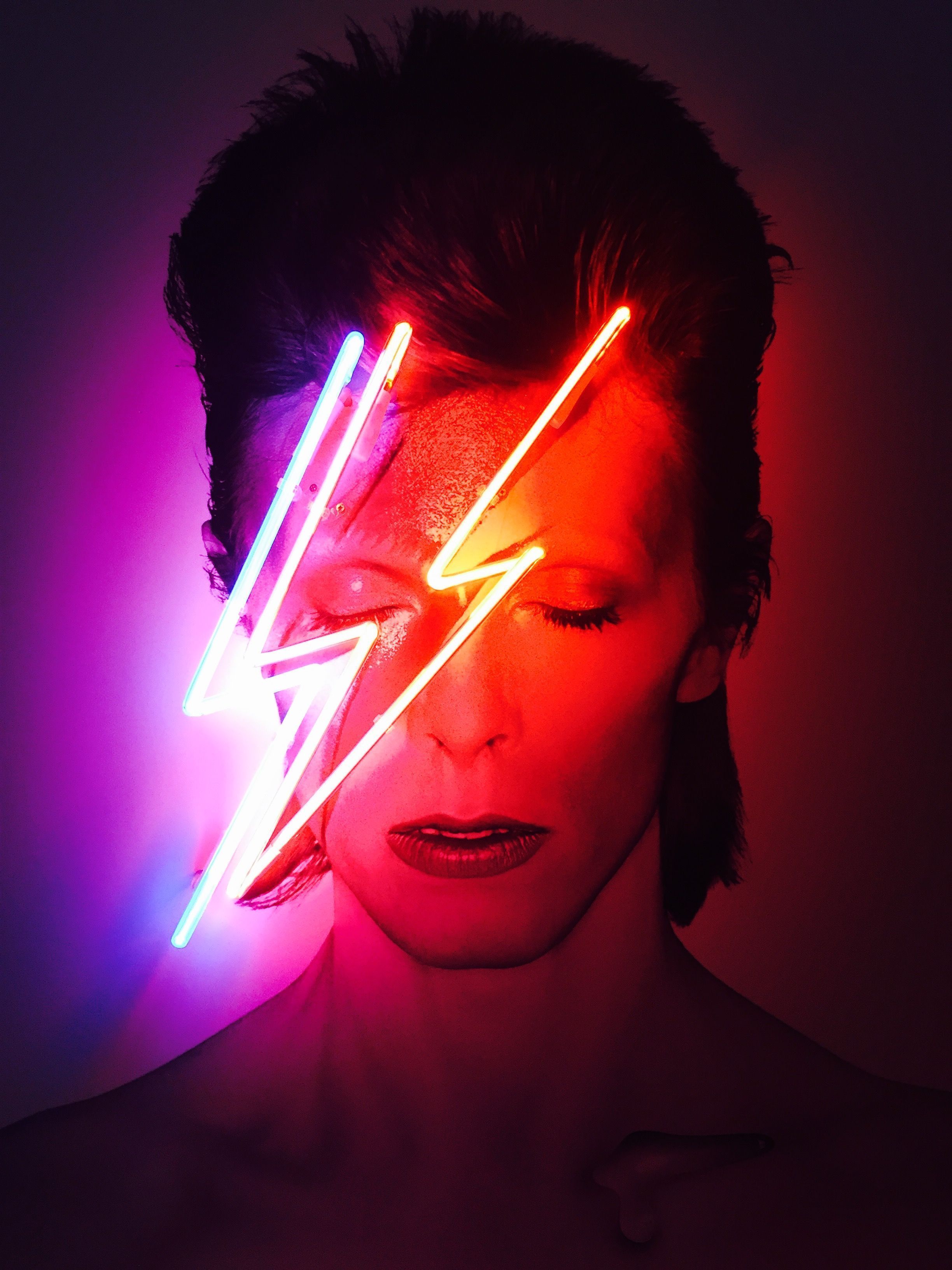 A man with neon lightning bolts on his face - David Bowie