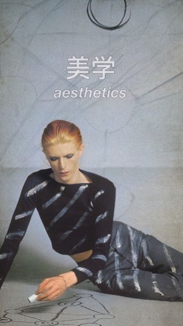 Aesthetic picture of a person in a black and silver top and pants. - David Bowie