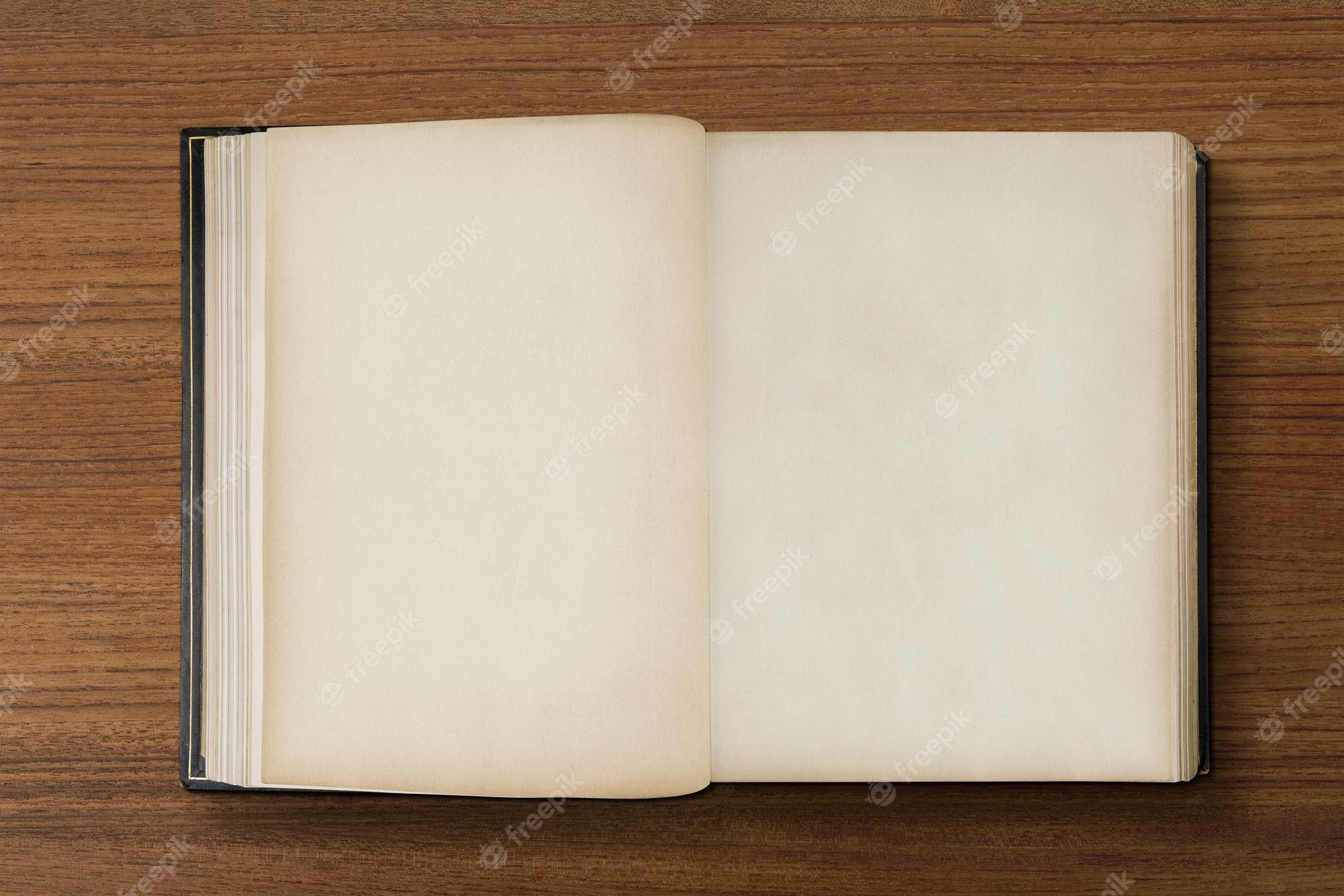 An open book on a wooden table - Books