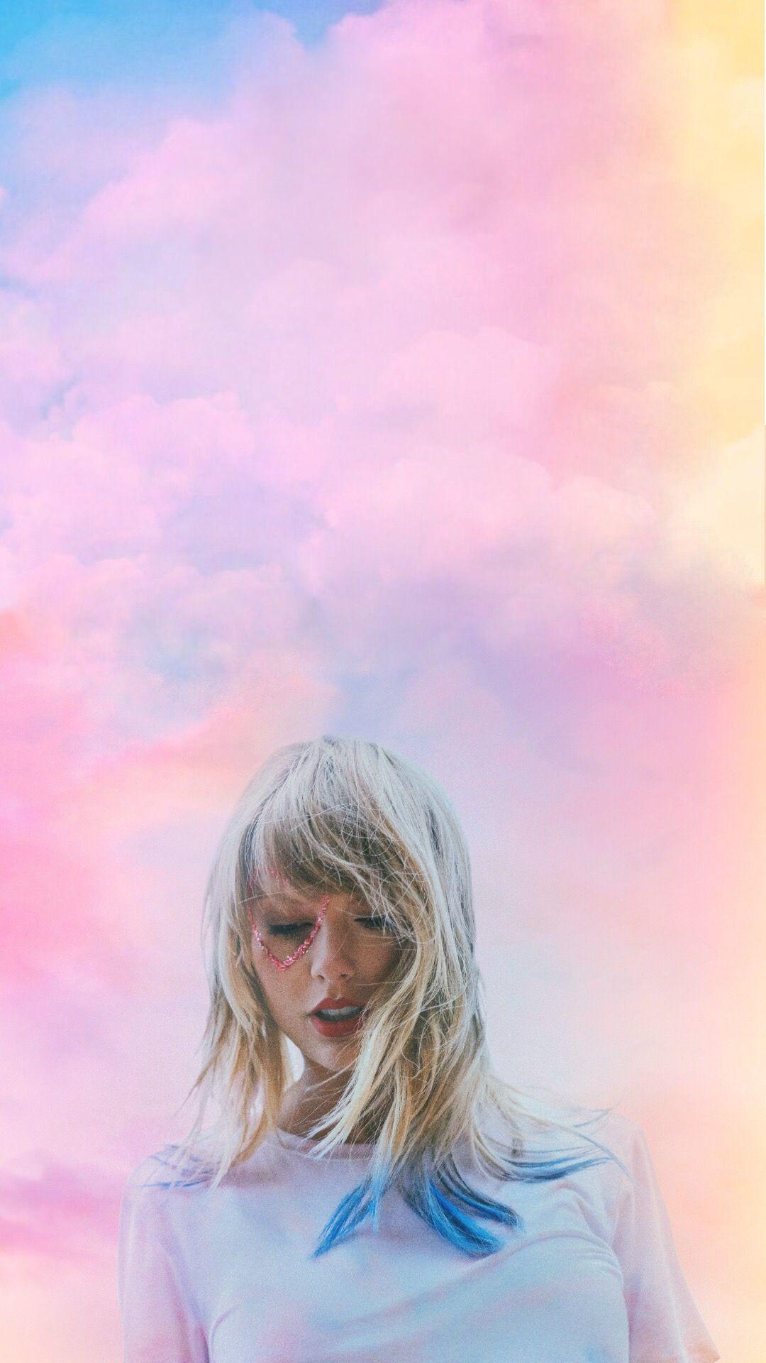 A woman with blue hair standing in front of the sky - Taylor Swift