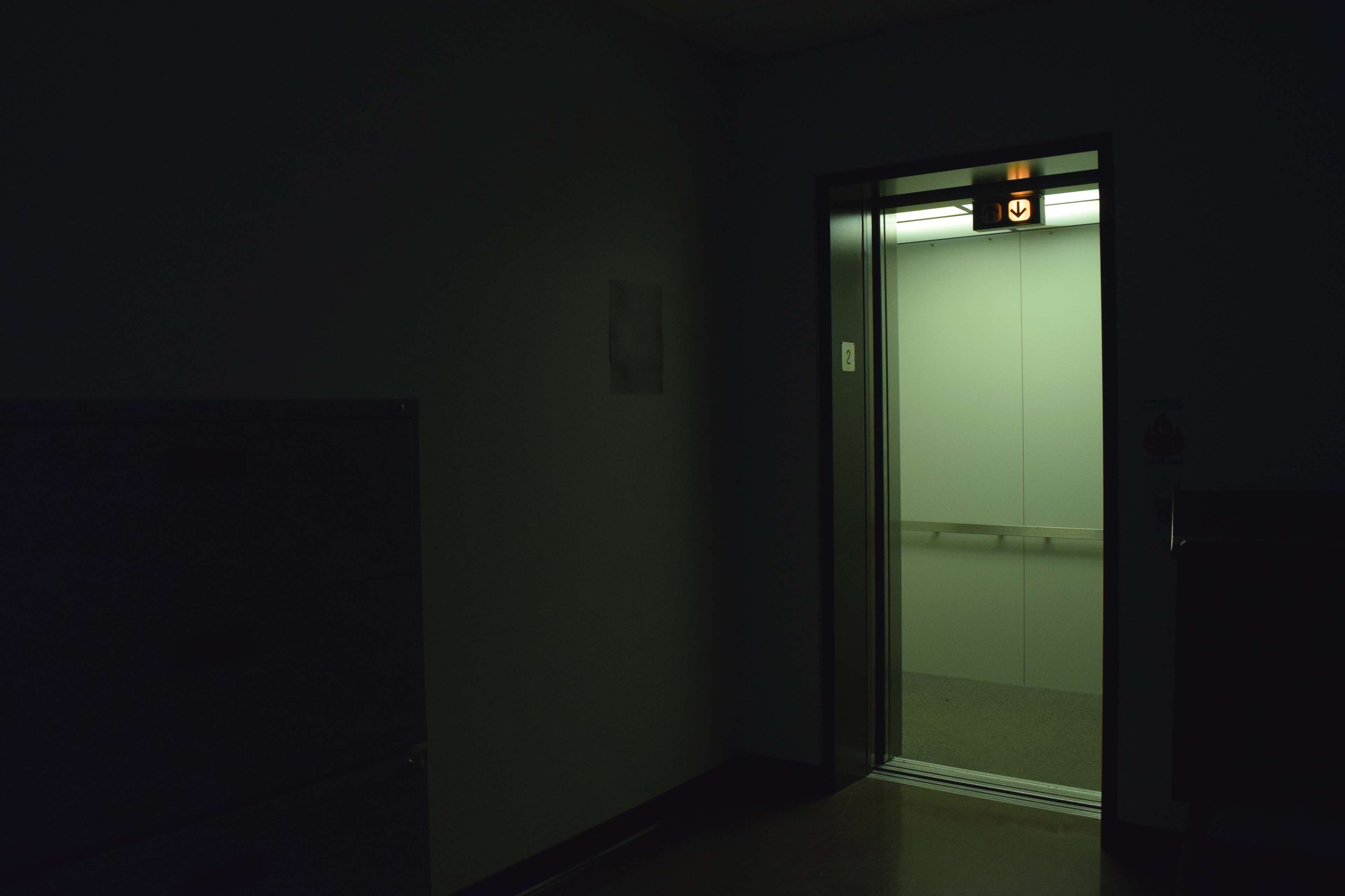 A dark hallway with an open door - Creepy