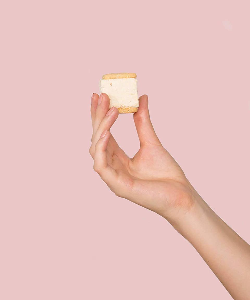 A person holding up an ice cream sandwich - Foodie