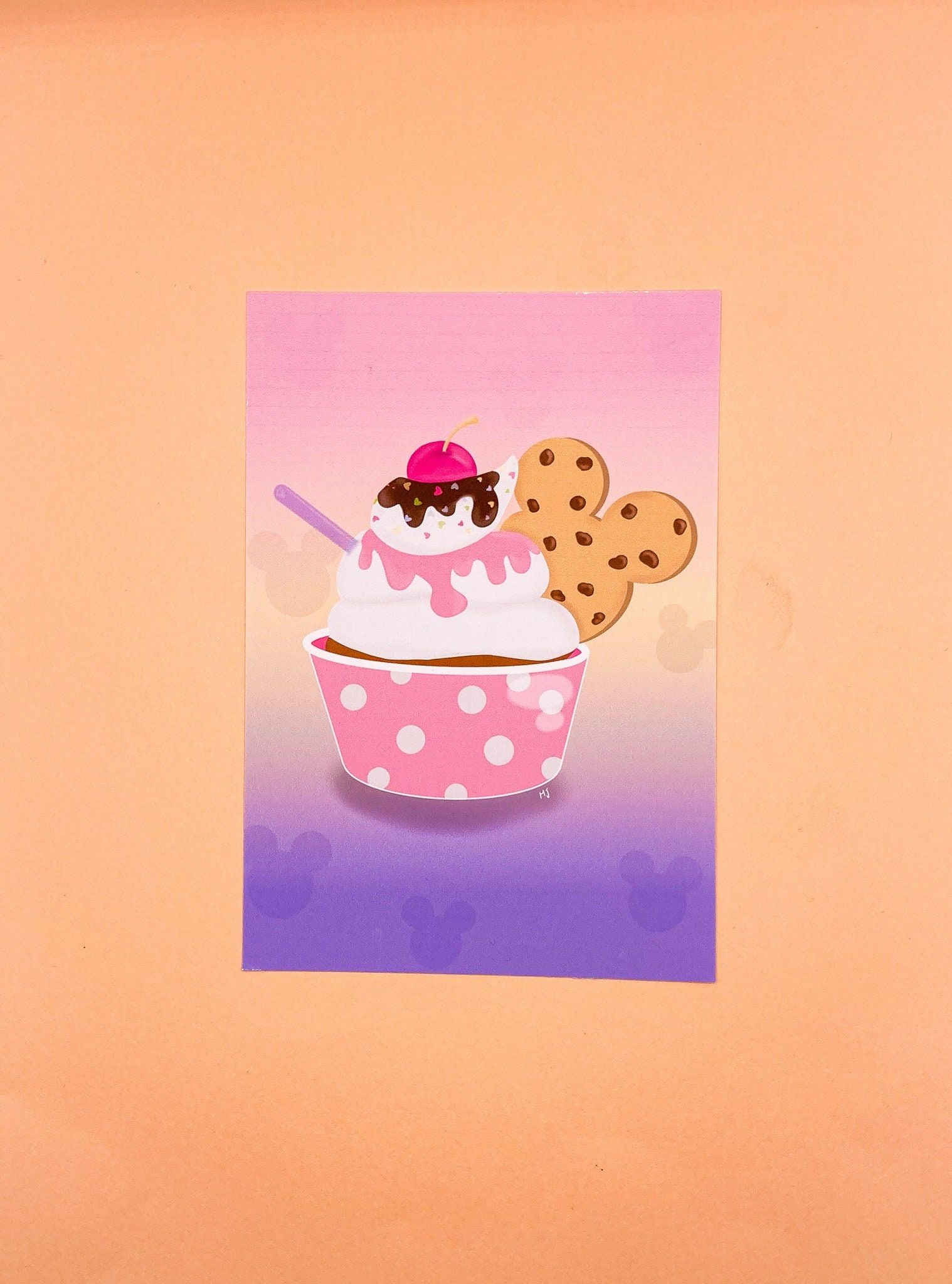 A postcard with a picture of a cup of ice cream with a cherry on top and a cookie sticking out of it. - Foodie