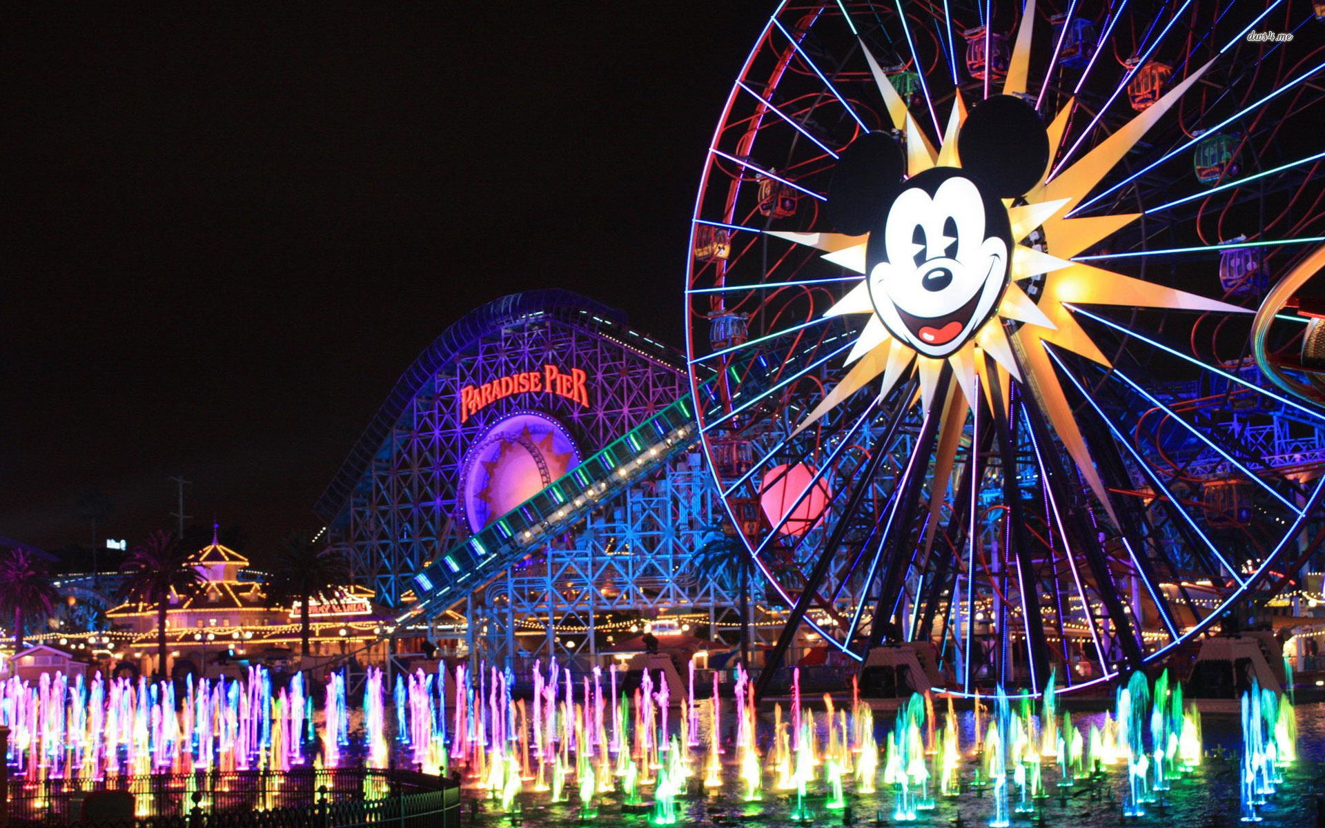 A ferris wheel with lights and water - Disneyland
