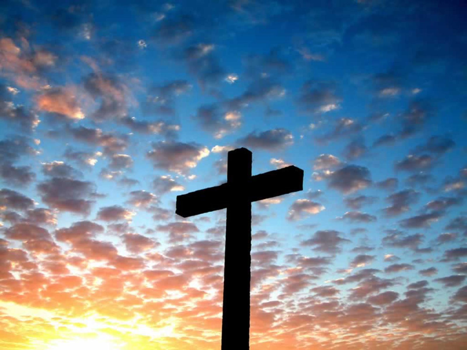 A cross against a blue sky with clouds - Cross