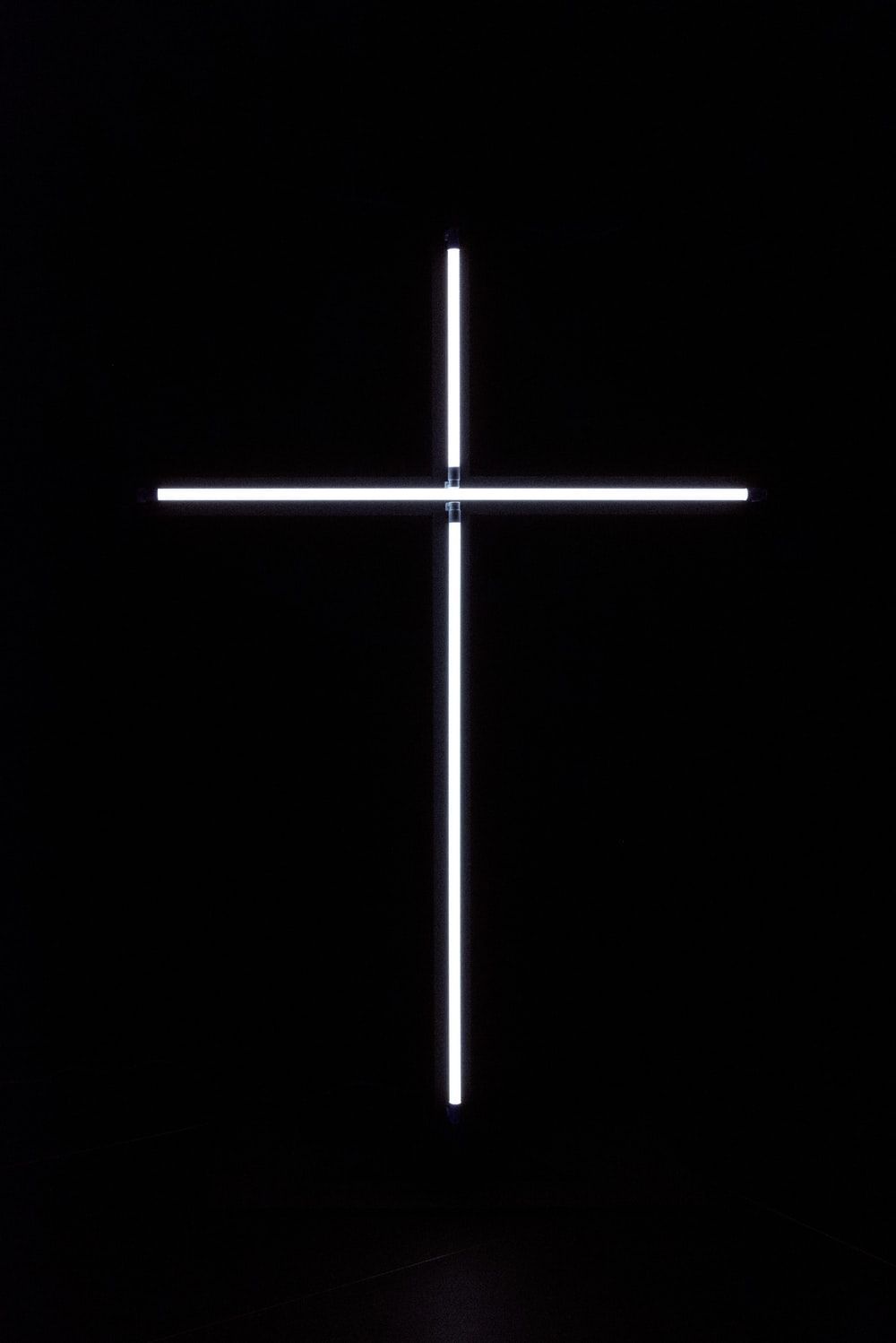 A white neon cross on a black background - Cross