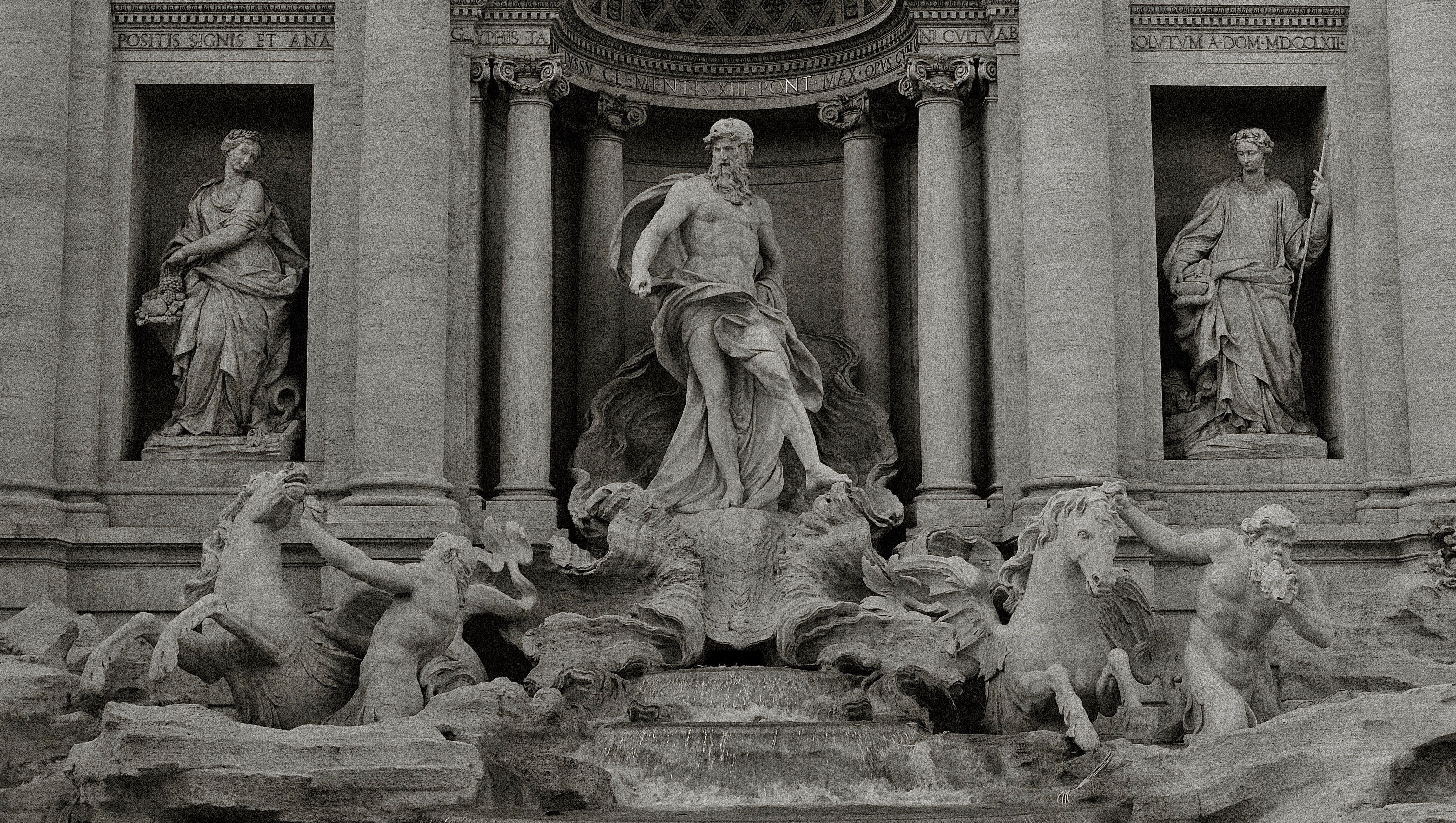 A beautiful statue in front of the Trevi fountain in Rome, Italy. - Greek statue