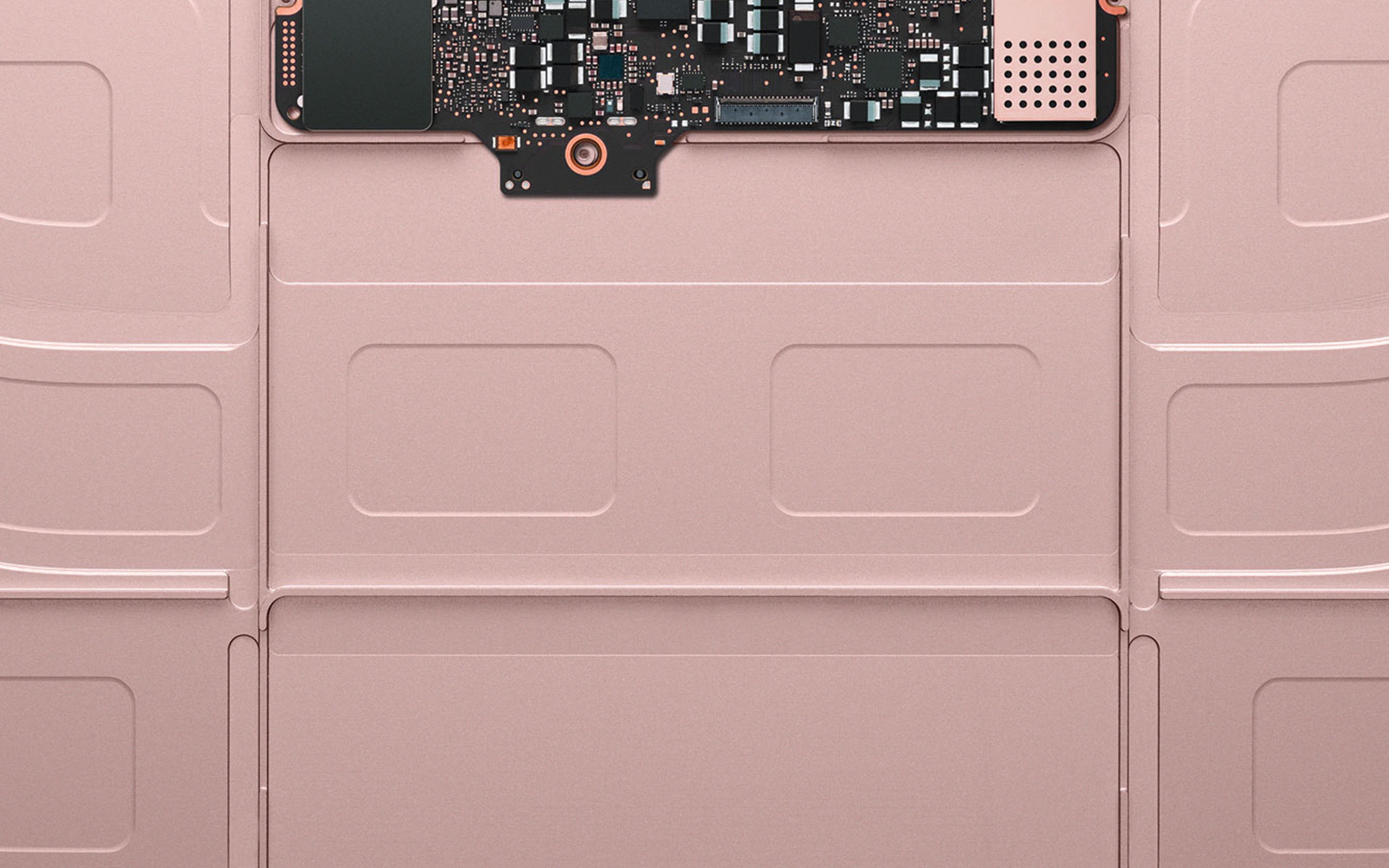 A pink laptop with the back off - MacBook