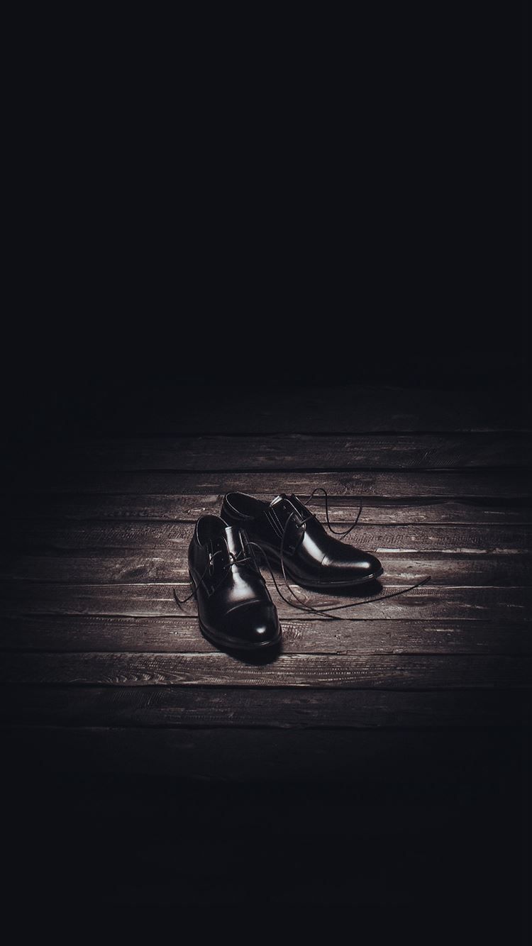 A pair of black leather shoes on a wooden floor - Shoes