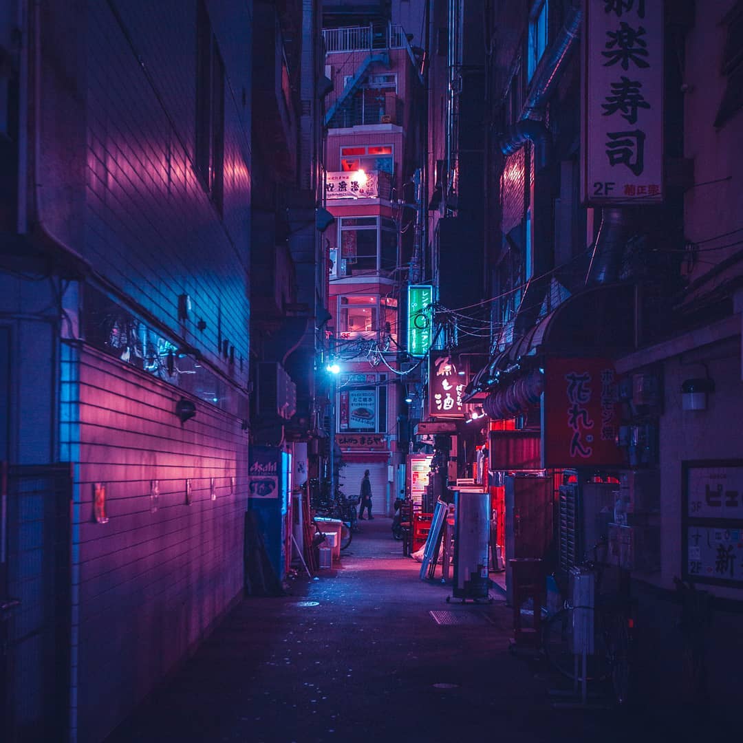 A street in Tokyo at night with the neon lights illuminating the scene - Tokyo