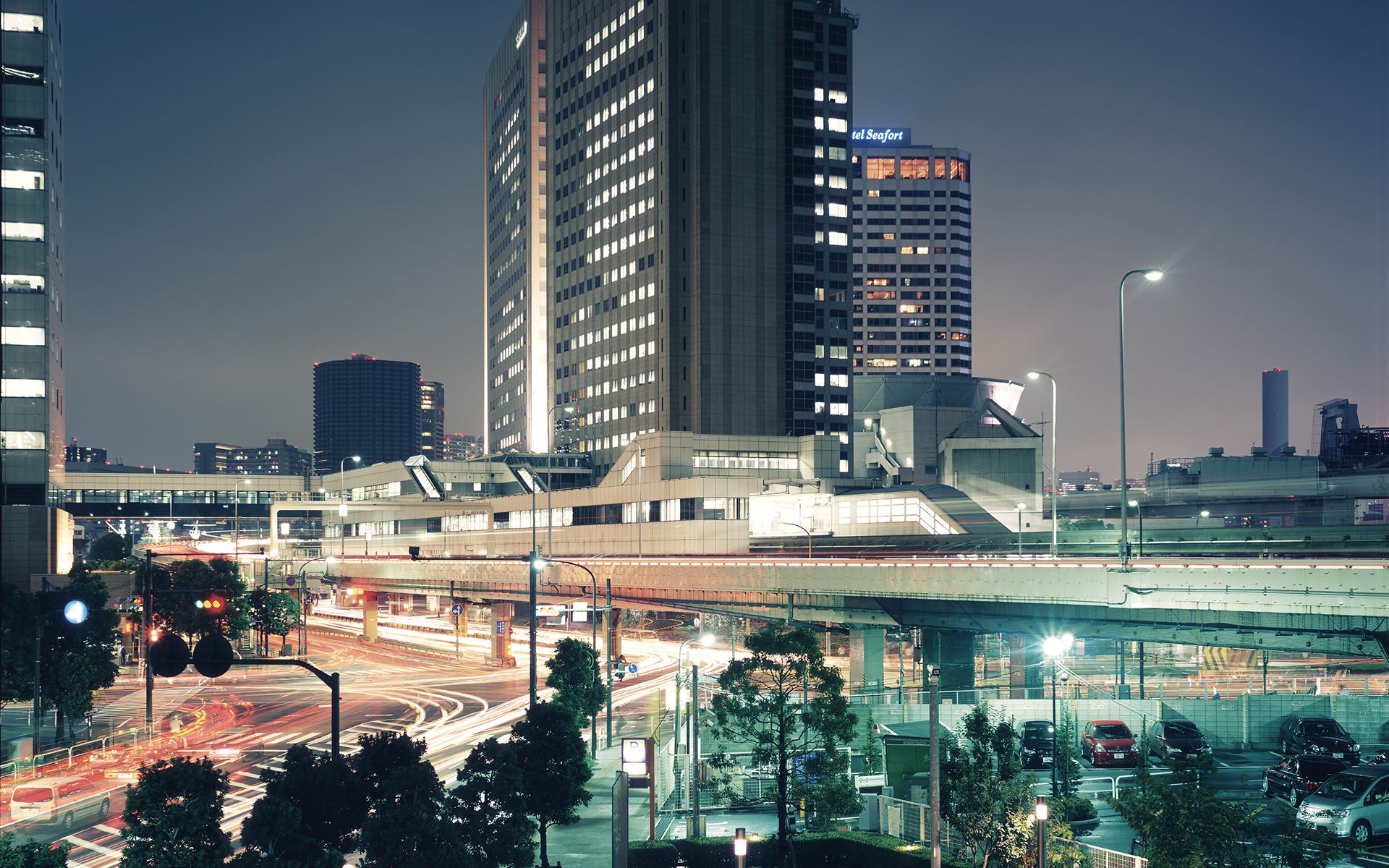 A city with tall buildings and traffic - Tokyo