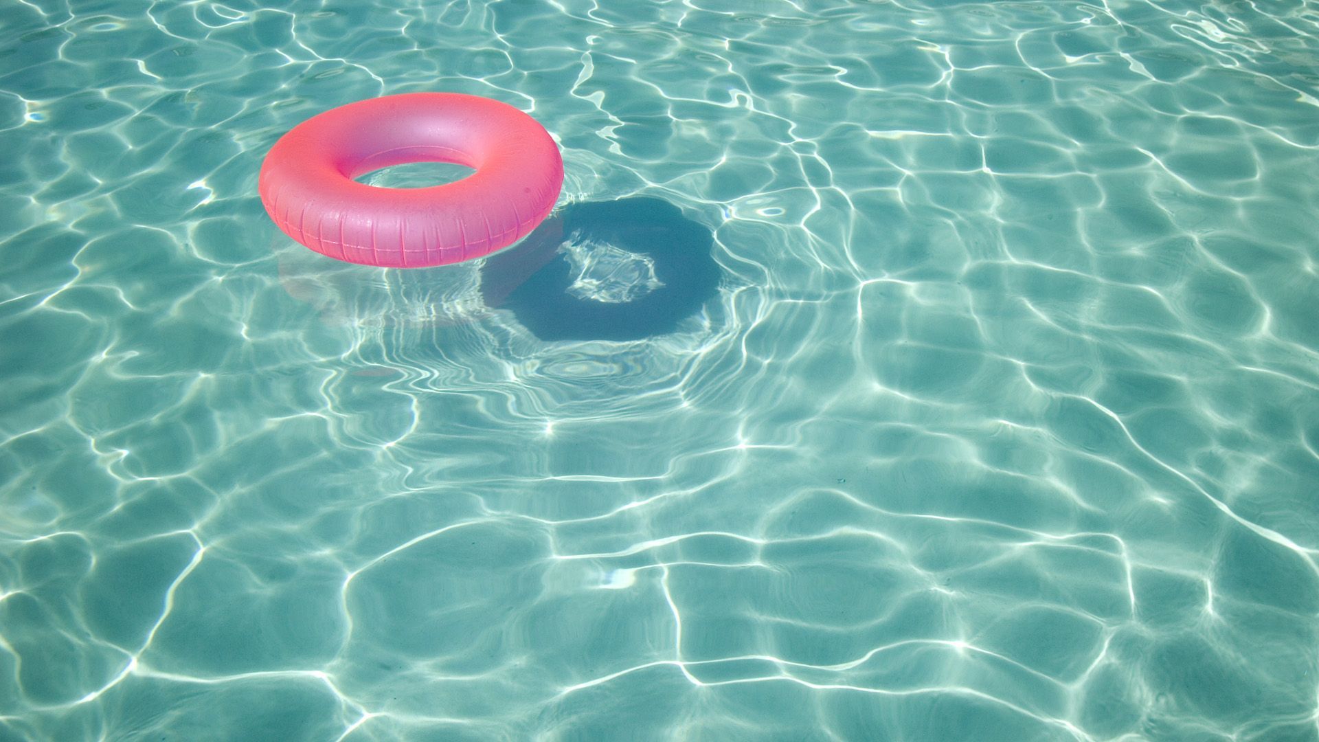 A pink float is floating in the water - Summer, swimming pool
