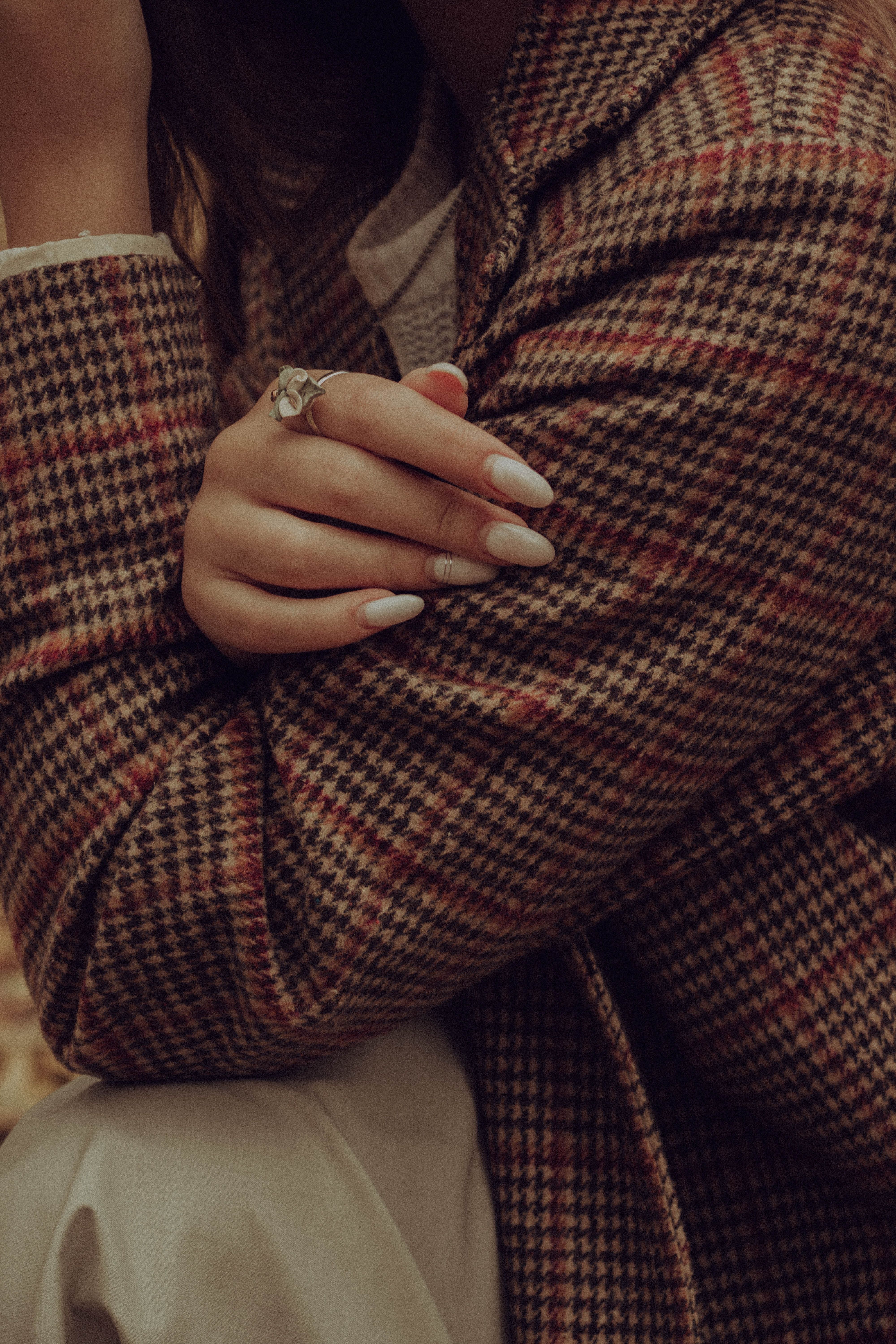 A woman wearing glasses and holding her phone - Nails