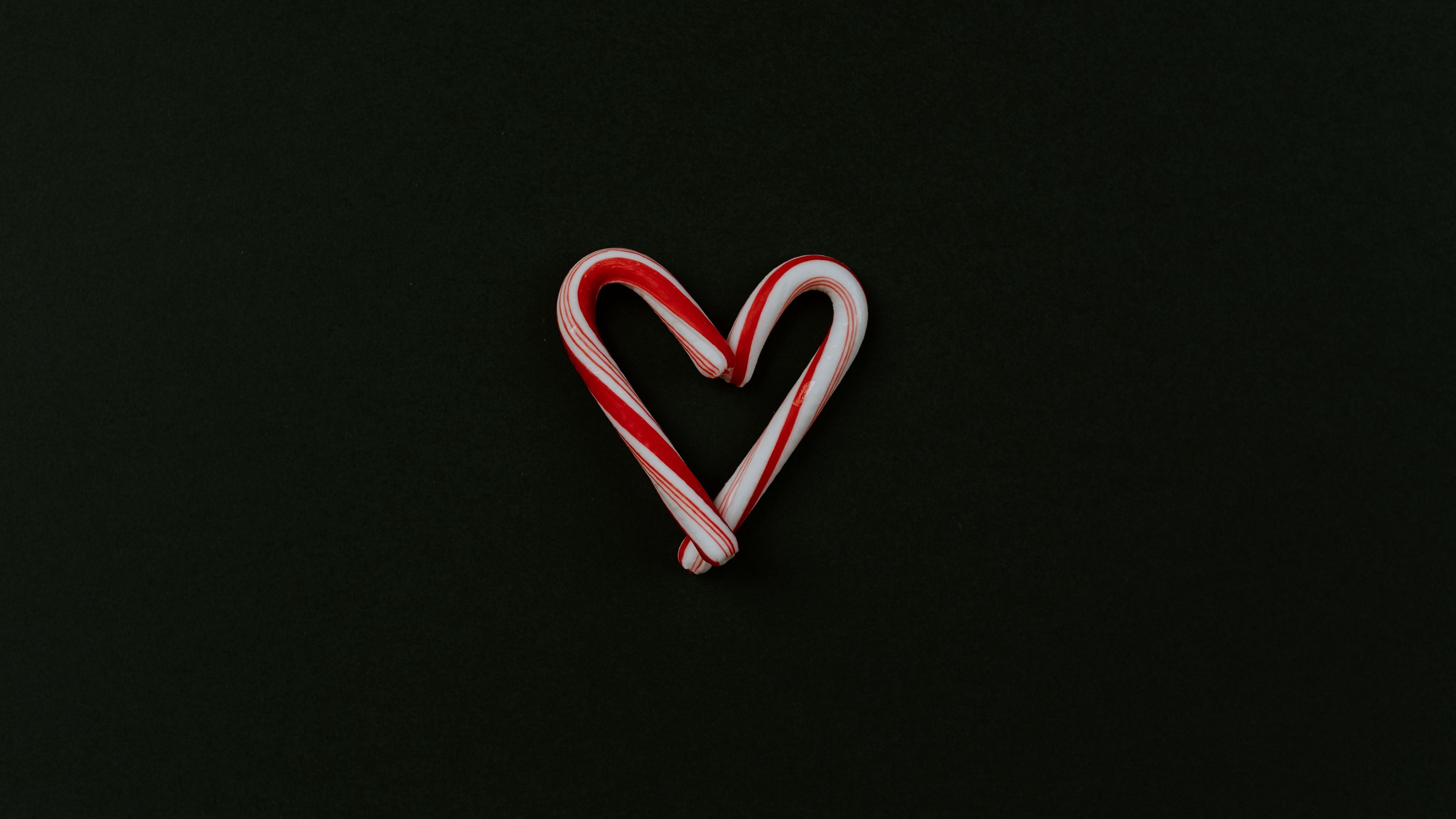 A candy cane in the shape of heart - Candy cane