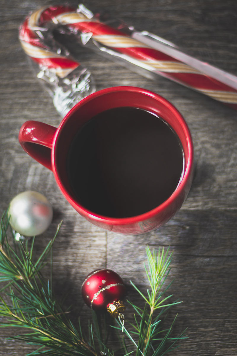 A cup of coffee and candy cane on the table - Candy cane