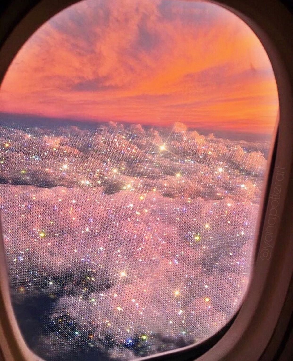 A city lit up below a plane window - Bling