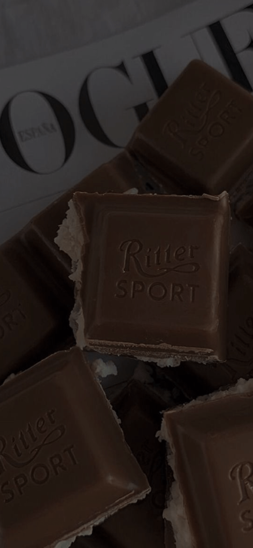 A box of Ritter Sport chocolate with a few pieces missing - Light brown, chocolate