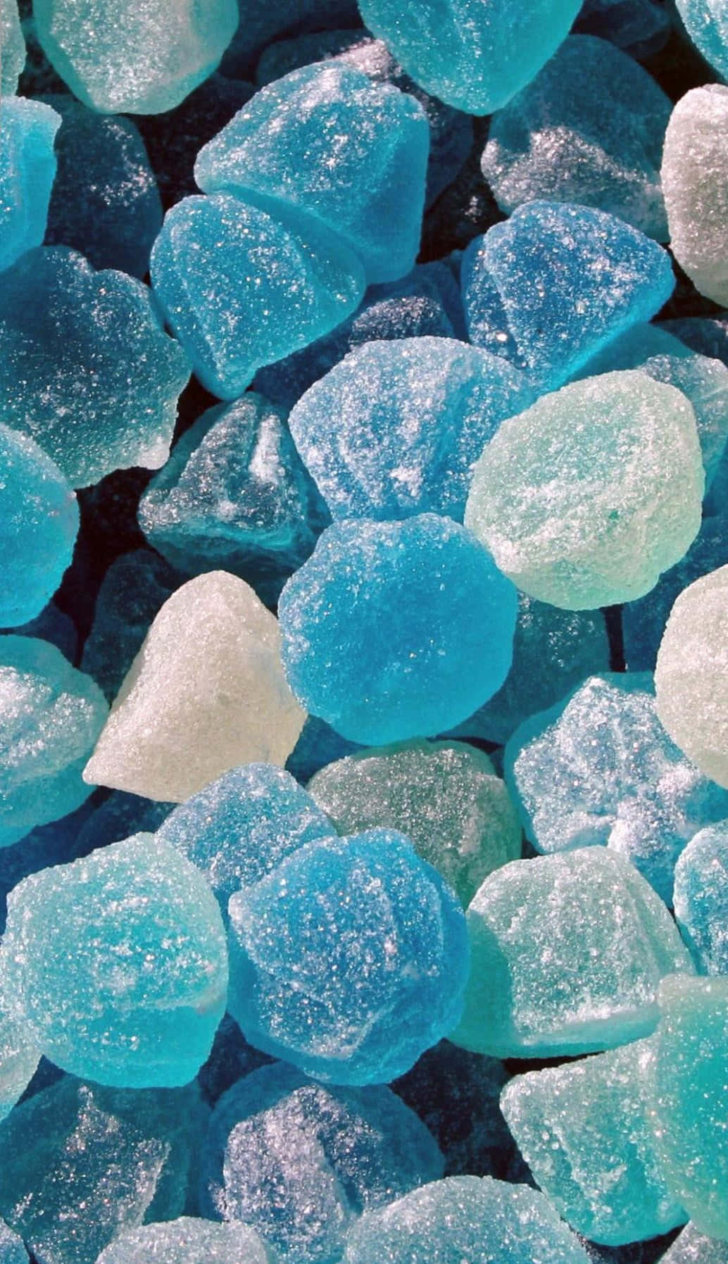 A pile of blue and white sugar coated hard candies - Teal, turquoise