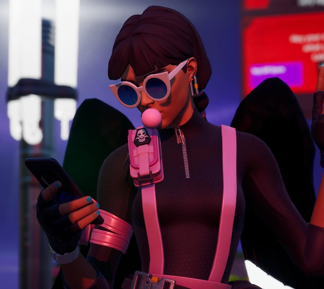 A Fortnite character wearing sunglasses and a pink clown nose looks at their phone. - Fortnite