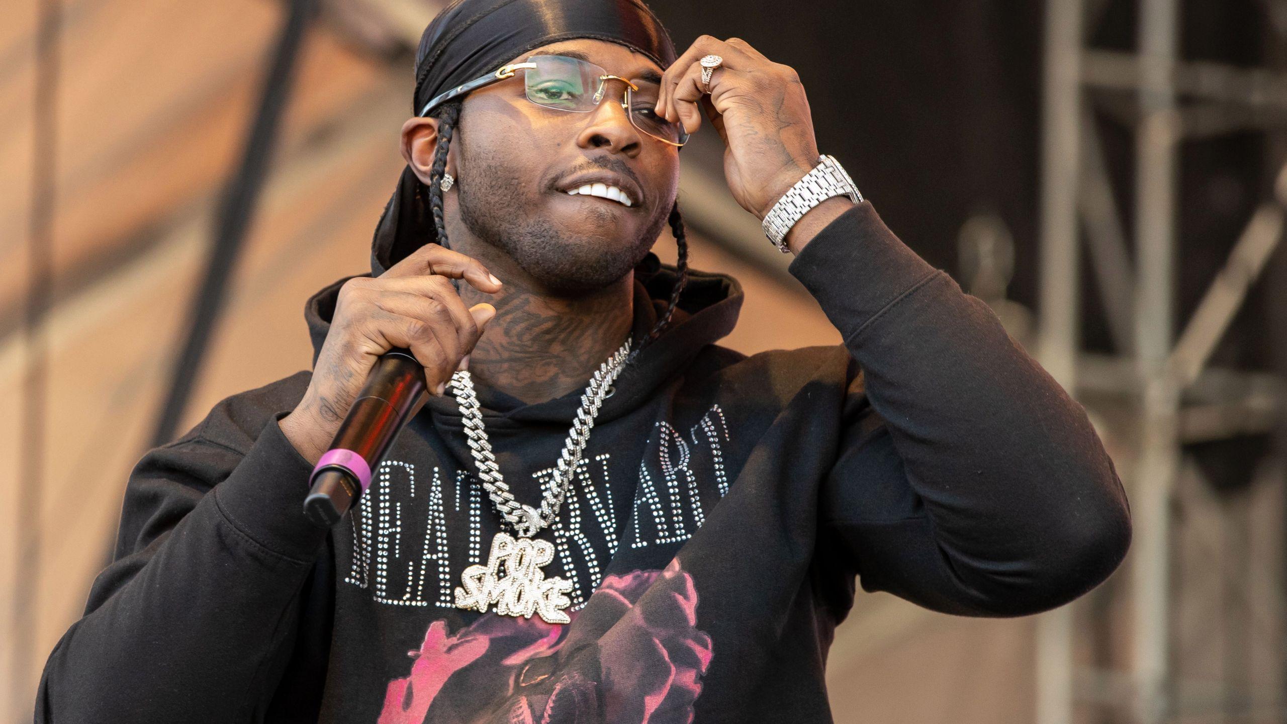 2 Chainz performing at a music festival - Pop Smoke