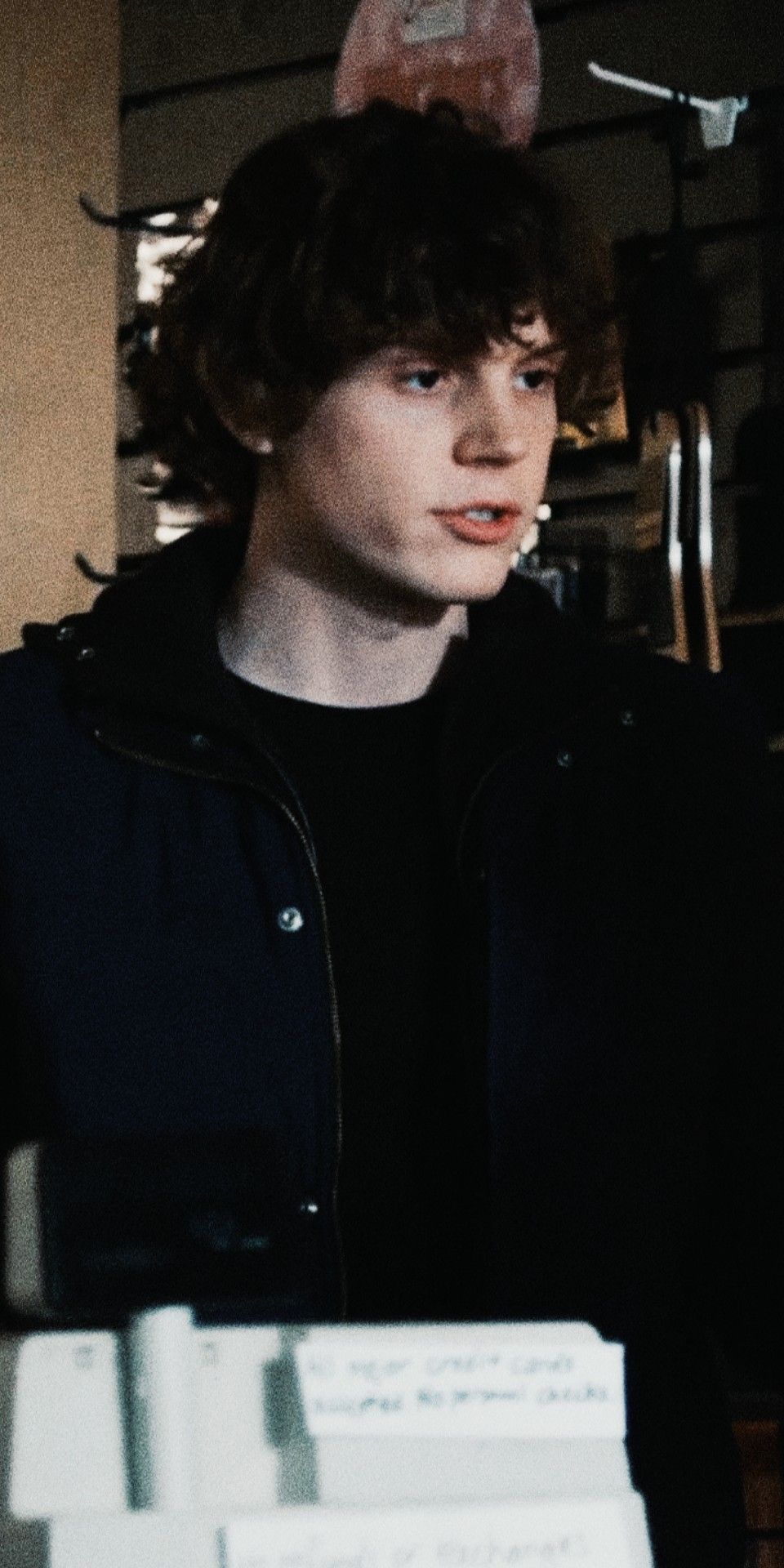 A man standing in front of some papers - Evan Peters