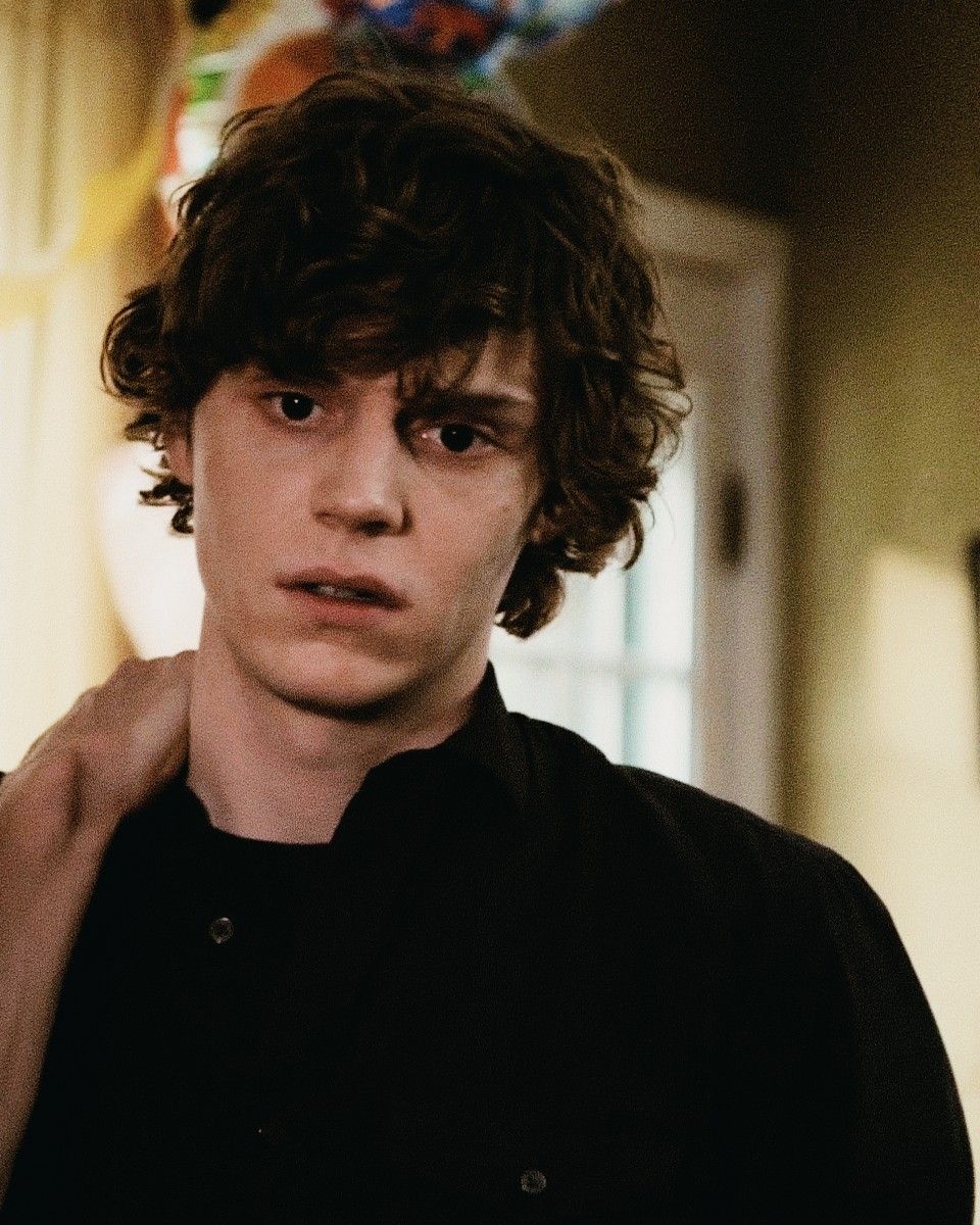 Evan Peters in a black shirt looking at the camera - Evan Peters